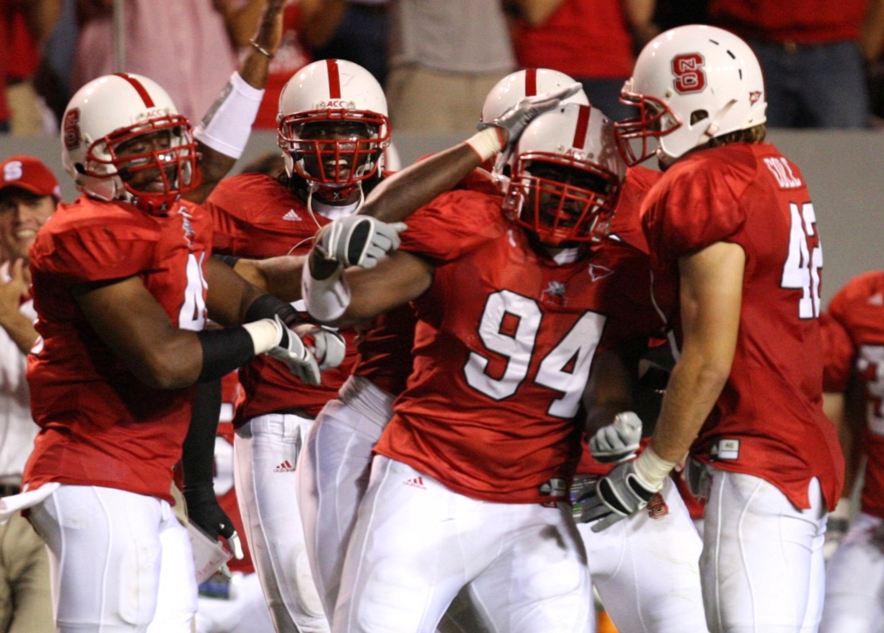 RALEIGH, NC - SEPTEMBER 3:  Grey Berry #94 of the North Carolina State Wolfpack celebrates with his teammates after making an interception against the South Carolina Gamecocks during the game at Carter-Finley Stadium on September 3, 2009 in Raleigh, North