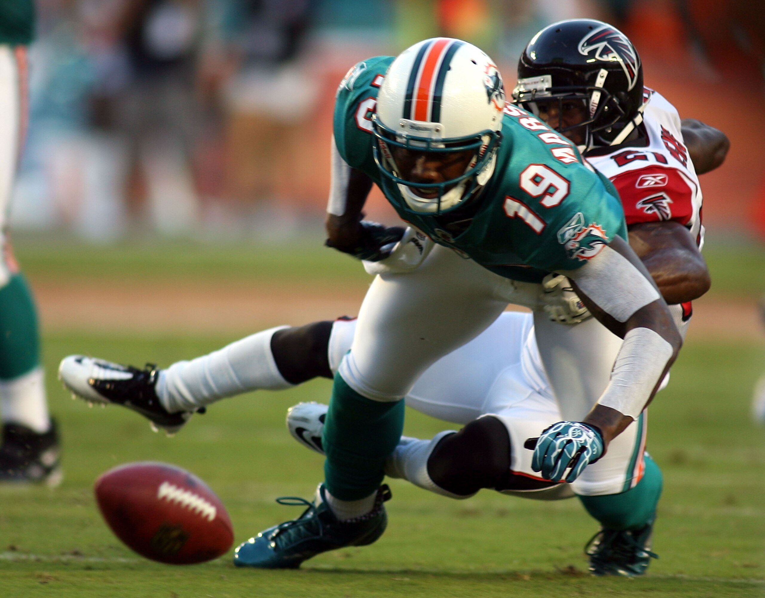 MIAMI - AUGUST 27:  Wide receiver Brandon Marshall #19 of the Miami Dolphins drops the ball against cornerback Brent Grimes #20 of the Atlanta Falcons at Sun Life Stadium on August 27, 2010 in Miami, Florida.  (Photo by Marc Serota/Getty Images)