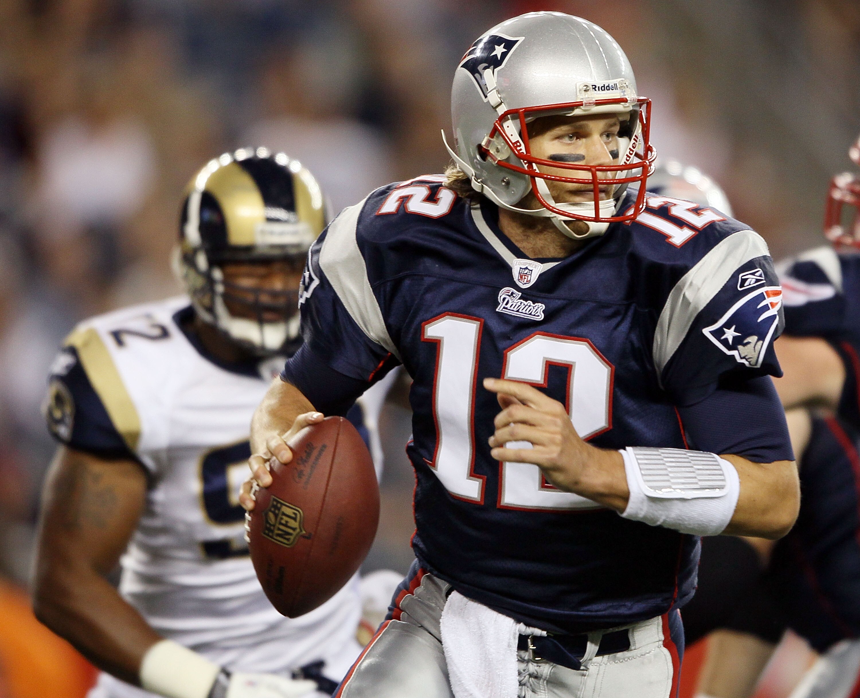 FOXBORO, MA - AUGUST 26:  Tom Brady #12 of the New England Patriots scrambles in the first half against the St. Louis Rams on August 26, 2010 at Gillette Stadium in Foxboro, Massachusetts.  (Photo by Elsa/Getty Images)