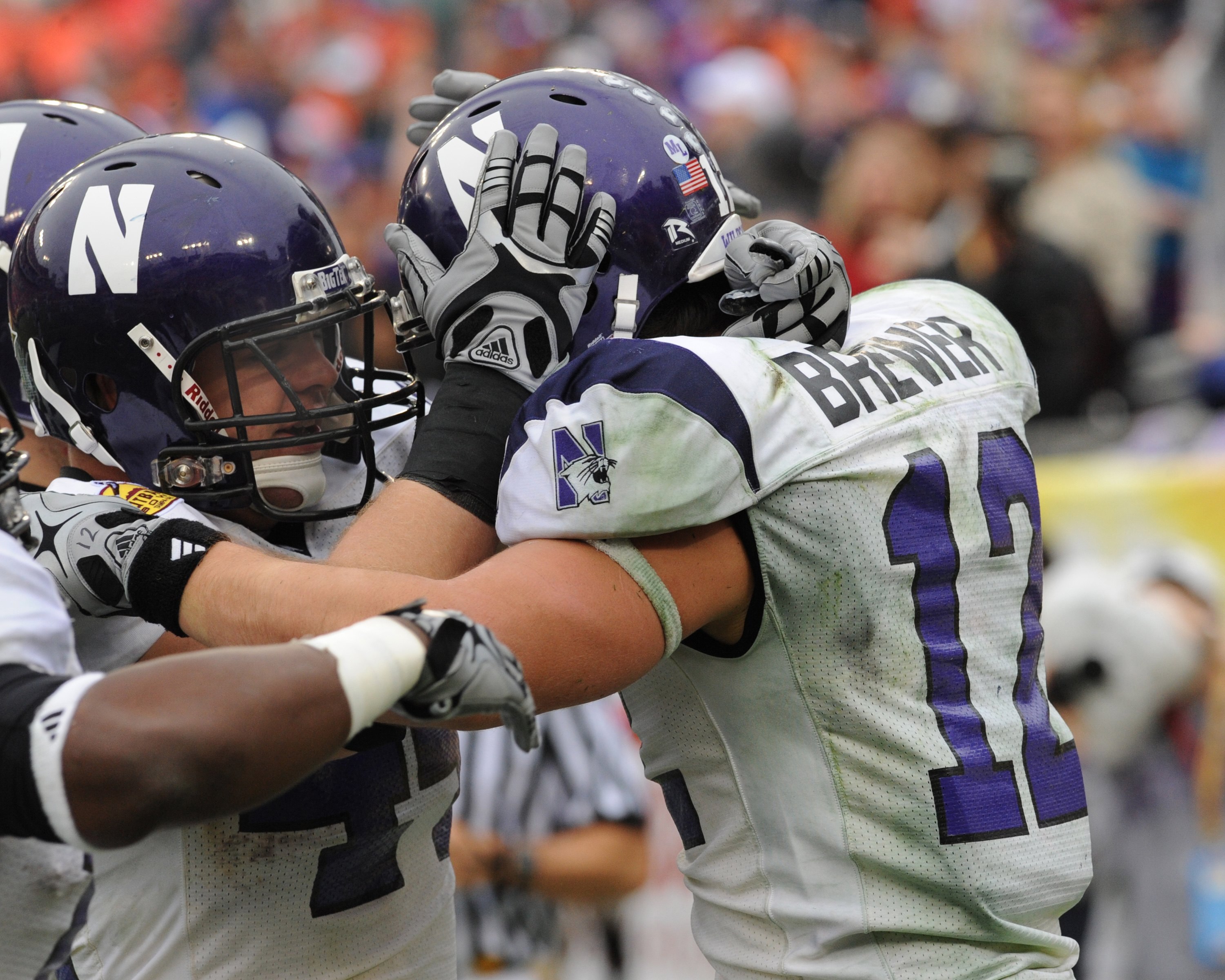 TAMPA, FL - JANUARY 1: Wide receiver Andrew Brewer #12 of the Northwestern Wildcats celebrates a touchdown pass with split back Mark Woodsum #44 against the Auburn Tigers in the Outback Bowl January 1, 2010 at Raymond James Stadium in Tampa, Florida.  (Ph