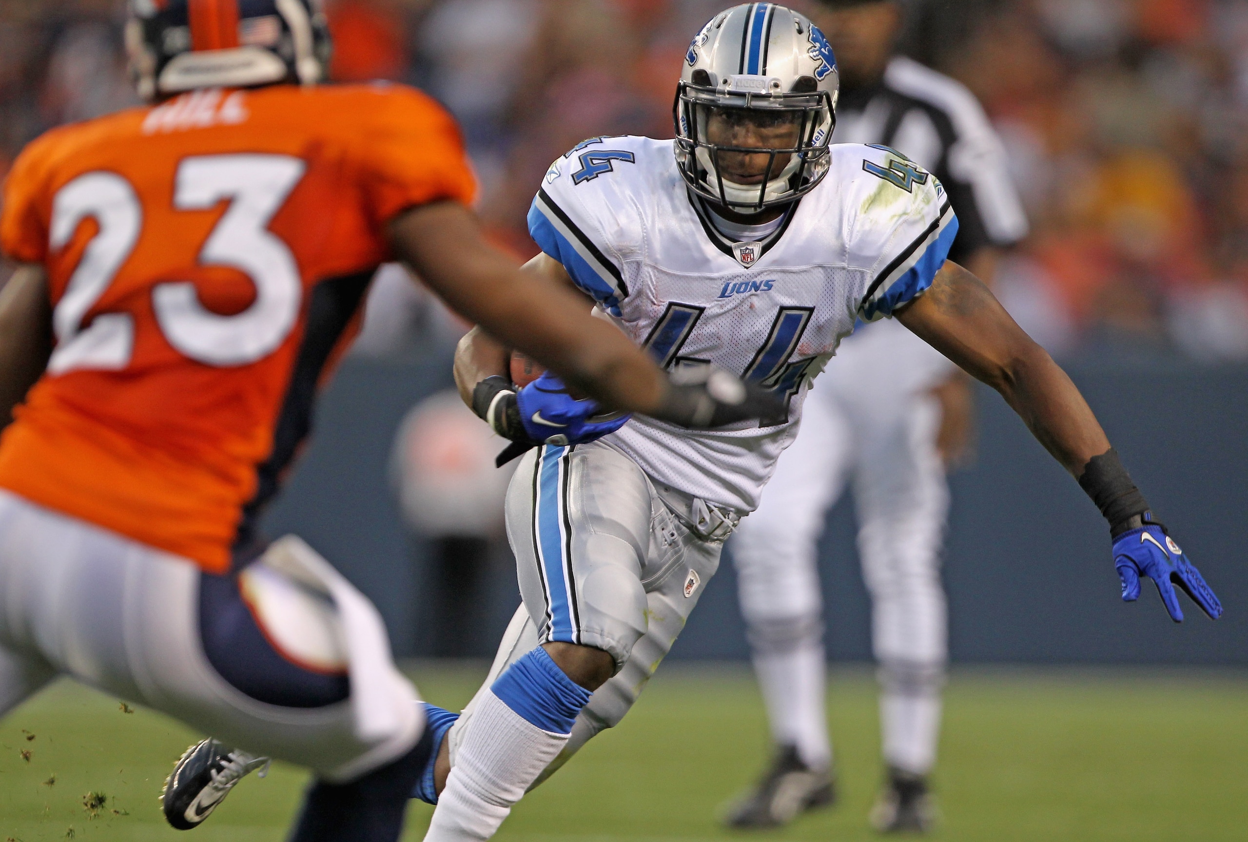 DENVER - AUGUST 21:  Jahvid Best #44 of the Detroit Lions rushes the ball as Renaldo Hill #23 of the Denver Broncos defends during preseason NFL action at INVESCO Field at Mile High on August 21, 2010 in Denver, Colorado. The Lions defeated the Broncos 25