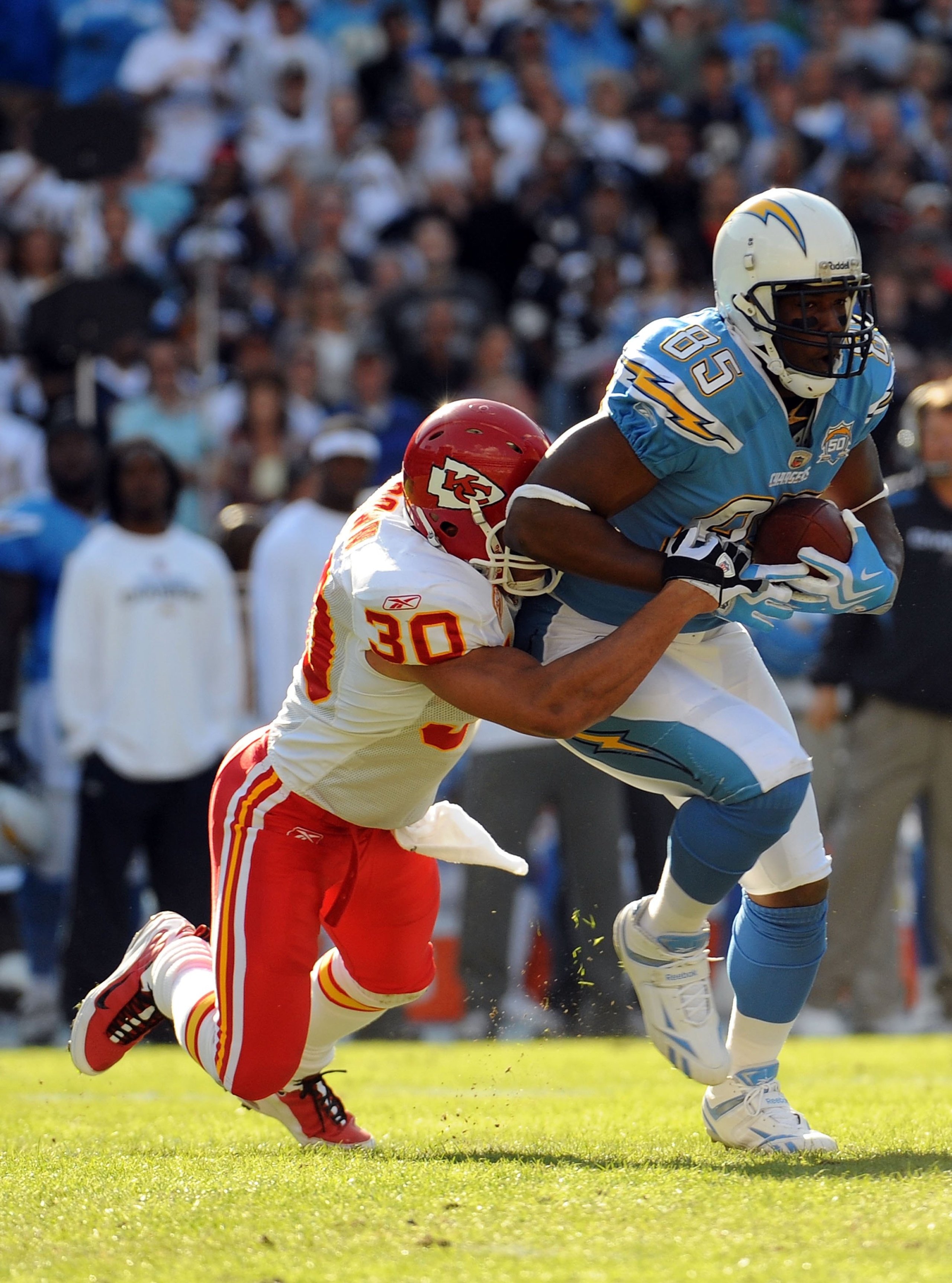 SAN DIEGO - NOVEMBER 29:  Antonio Gates #85 of the San Diego Chargers runs after his catch as he is tackled by Mike Brown #30 of the Kansas City Chiefs during the game at Qualcomm Stadium on November 29, 2009 in San Diego, California.  (Photo by Harry How