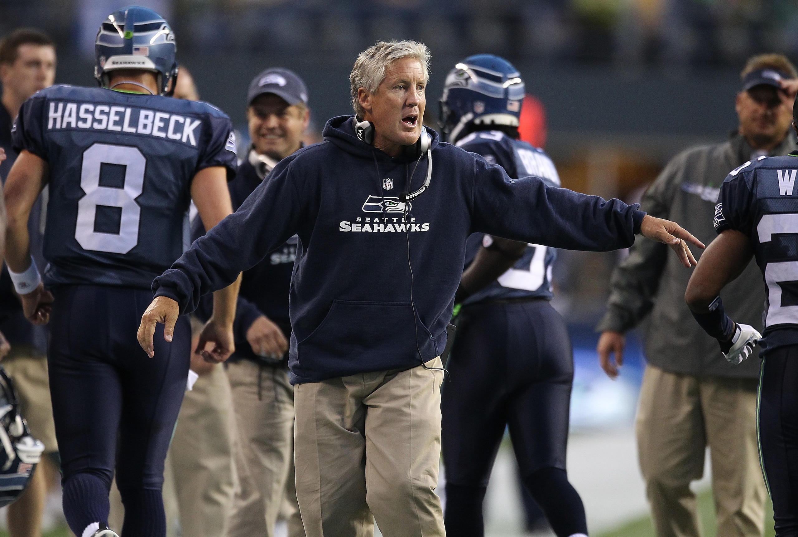 SEATTLE - AUGUST 21:  Head coach Pete Carroll of the Seattle Seahawks congratulates players after the Seahawks scored a touchdown in the first half during the preseason game against the Green Bay Packers at Qwest Field on August 21, 2010 in Seattle, Washi