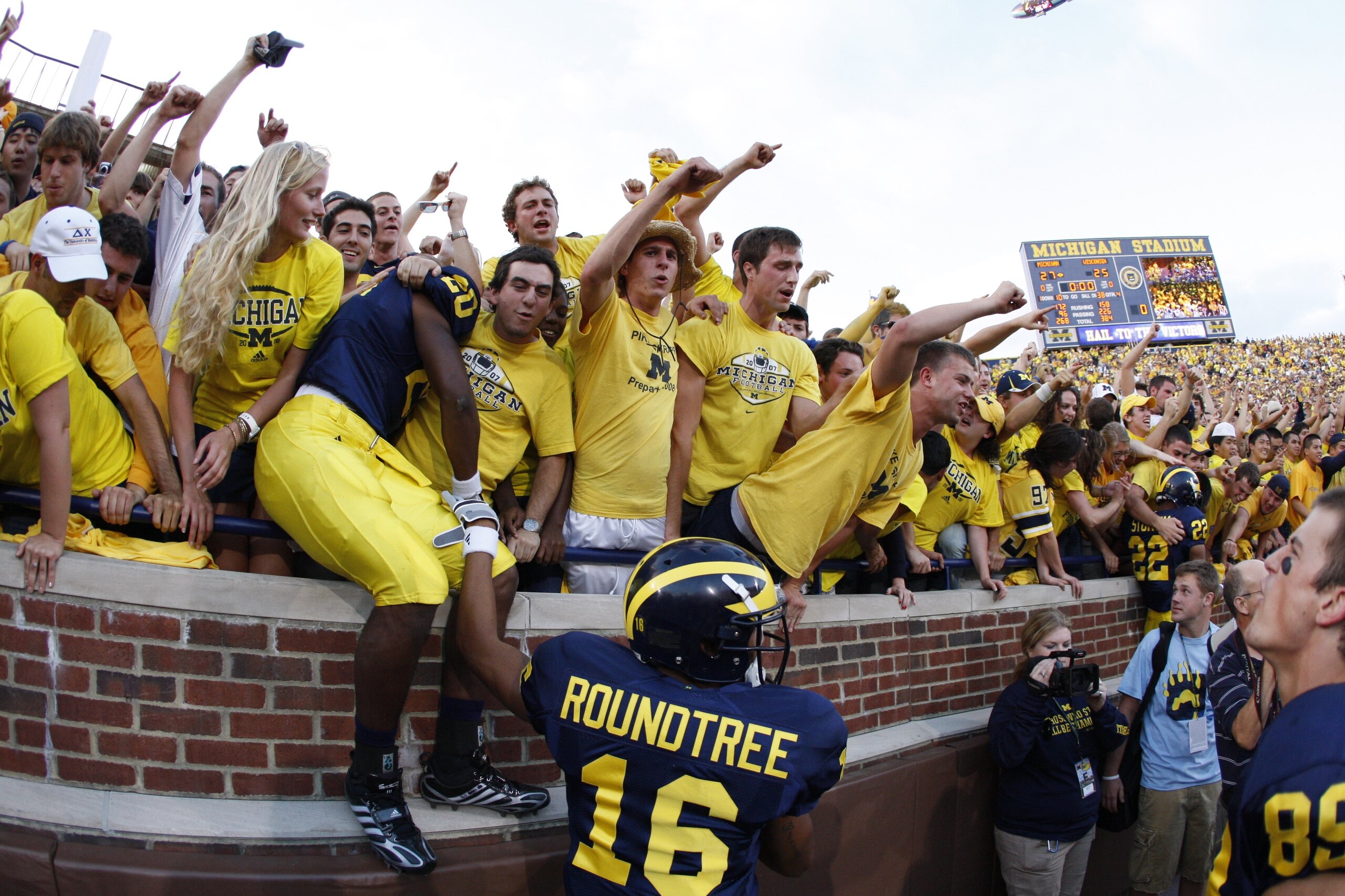 ANN ARBOR, MI - SEPTEMBER 27:  Michael Shaw #20 and Roy Roundtree #16 of the Michigan Wolverines celebrate with fans following the game against the Wisconsin Badgers on September 27, 2008 at Michigan Stadium in Ann Arbor, Michigan. (Photo by Gregory Shamu