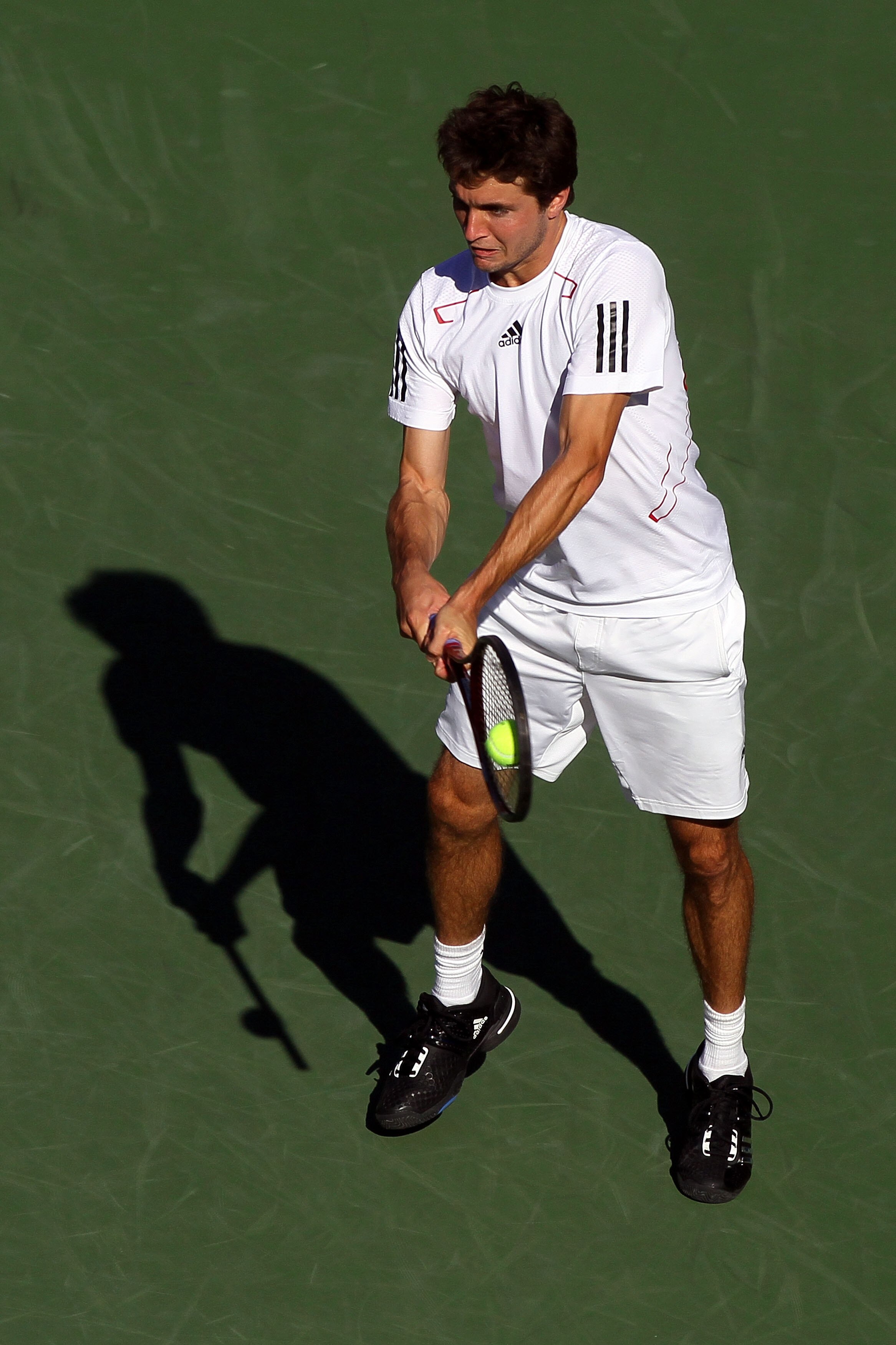 NEW YORK - SEPTEMBER 05:  Gilles Simon of France returns a shot against Rafael Nadal of Spain during the men's singles match on day seven of the 2010 U.S. Open at the USTA Billie Jean King National Tennis Center on September 5, 2010 in the Flushing neighb