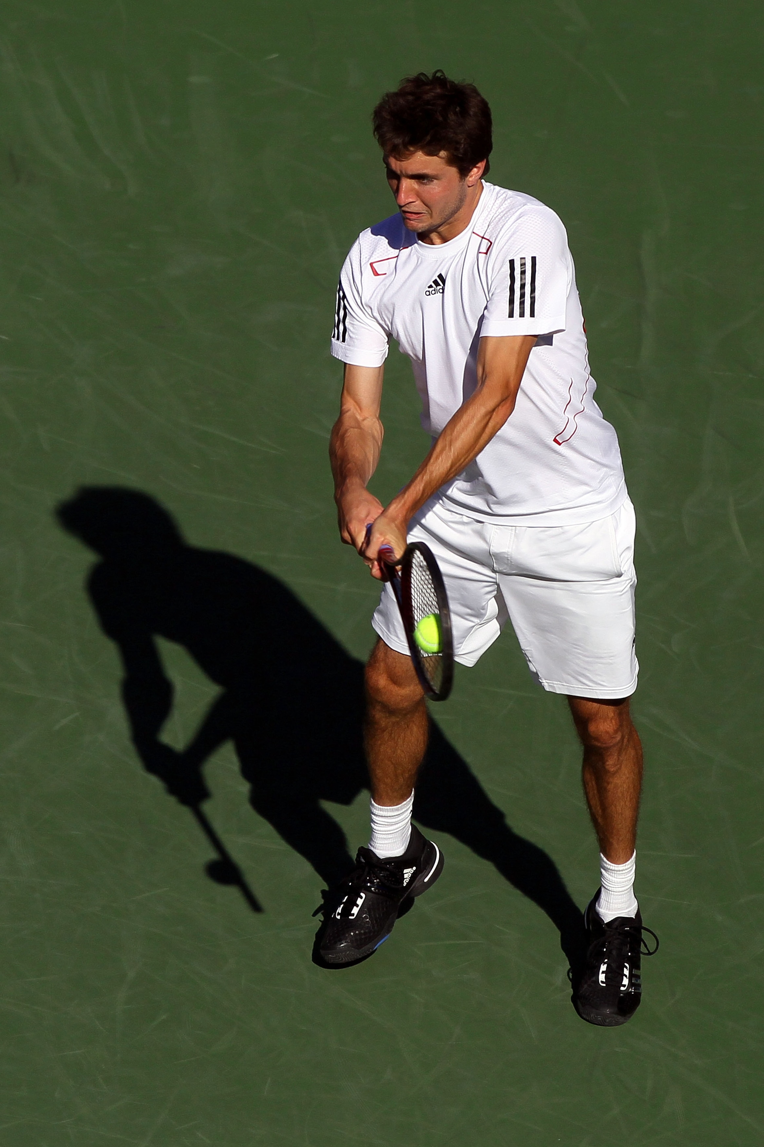 NEW YORK - SEPTEMBER 05:  Gilles Simon of France returns a shot against Rafael Nadal of Spain during the men's singles match on day seven of the 2010 U.S. Open at the USTA Billie Jean King National Tennis Center on September 5, 2010 in the Flushing neighb