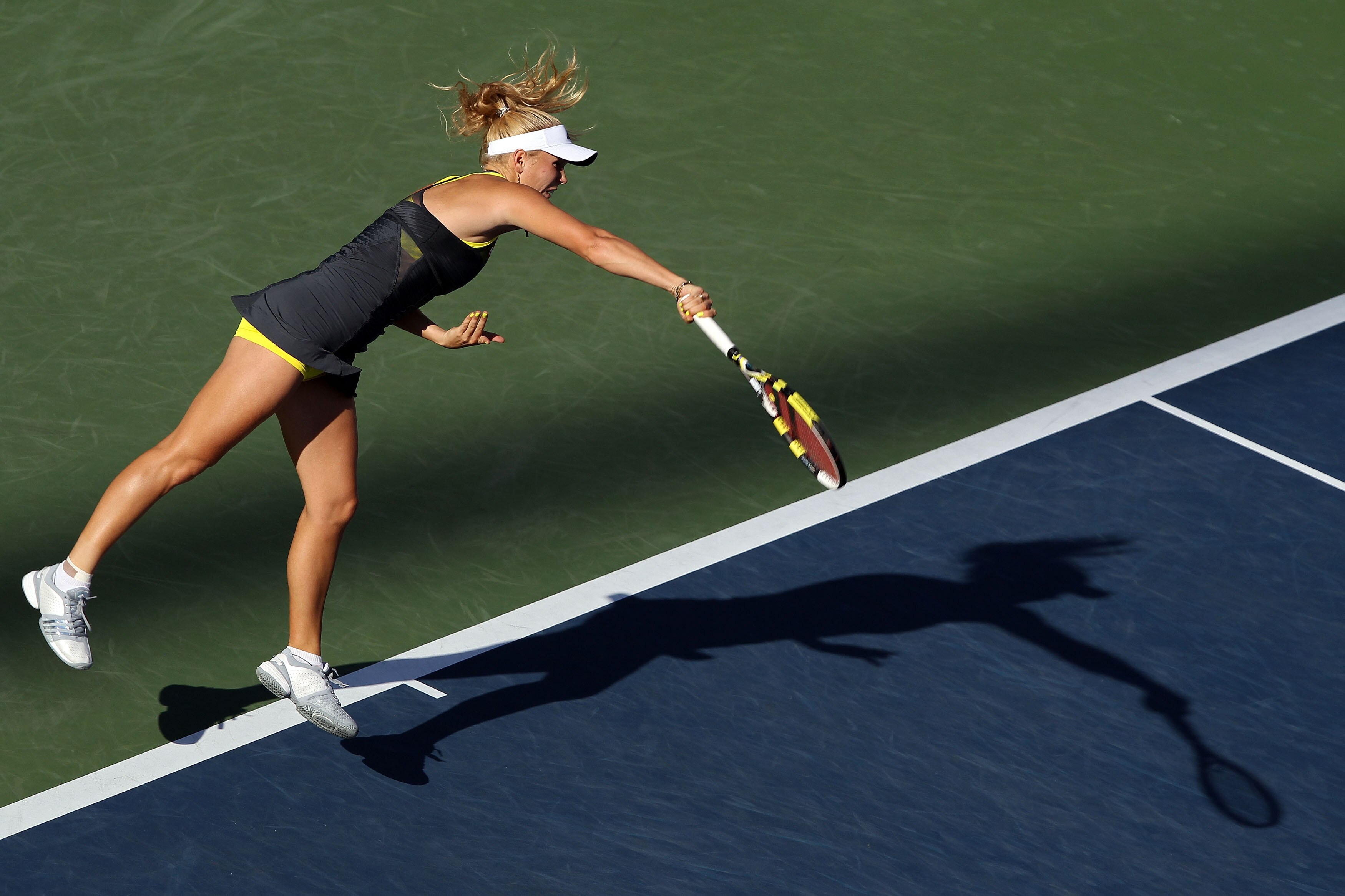 NEW YORK - SEPTEMBER 06:  Caroline Wozniacki of Denmark serves against Maria Sharapova of Russia during the women's singles match on day eight of the 2010 U.S. Open at the USTA Billie Jean King National Tennis Center on September 6, 2010 in the Flushing n
