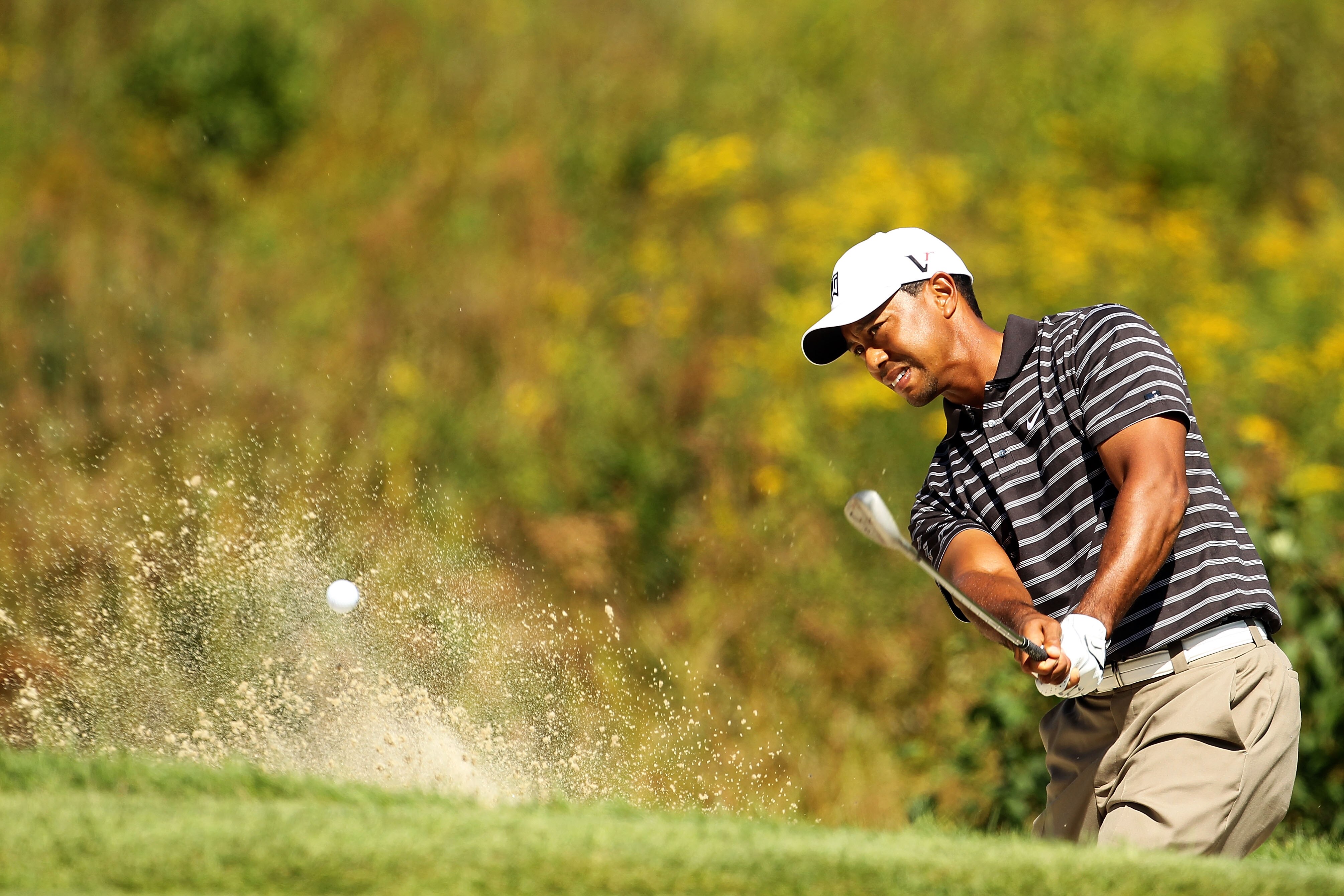 NORTON, MA - SEPTEMBER 05:  Tiger Woods hits a shot out of the bunker on the third hole during the third round of the Deutsche Bank Championship at TPC Boston on September 5, 2010 in Norton, Massachusetts.  (Photo by Mike Ehrmann/Getty Images)