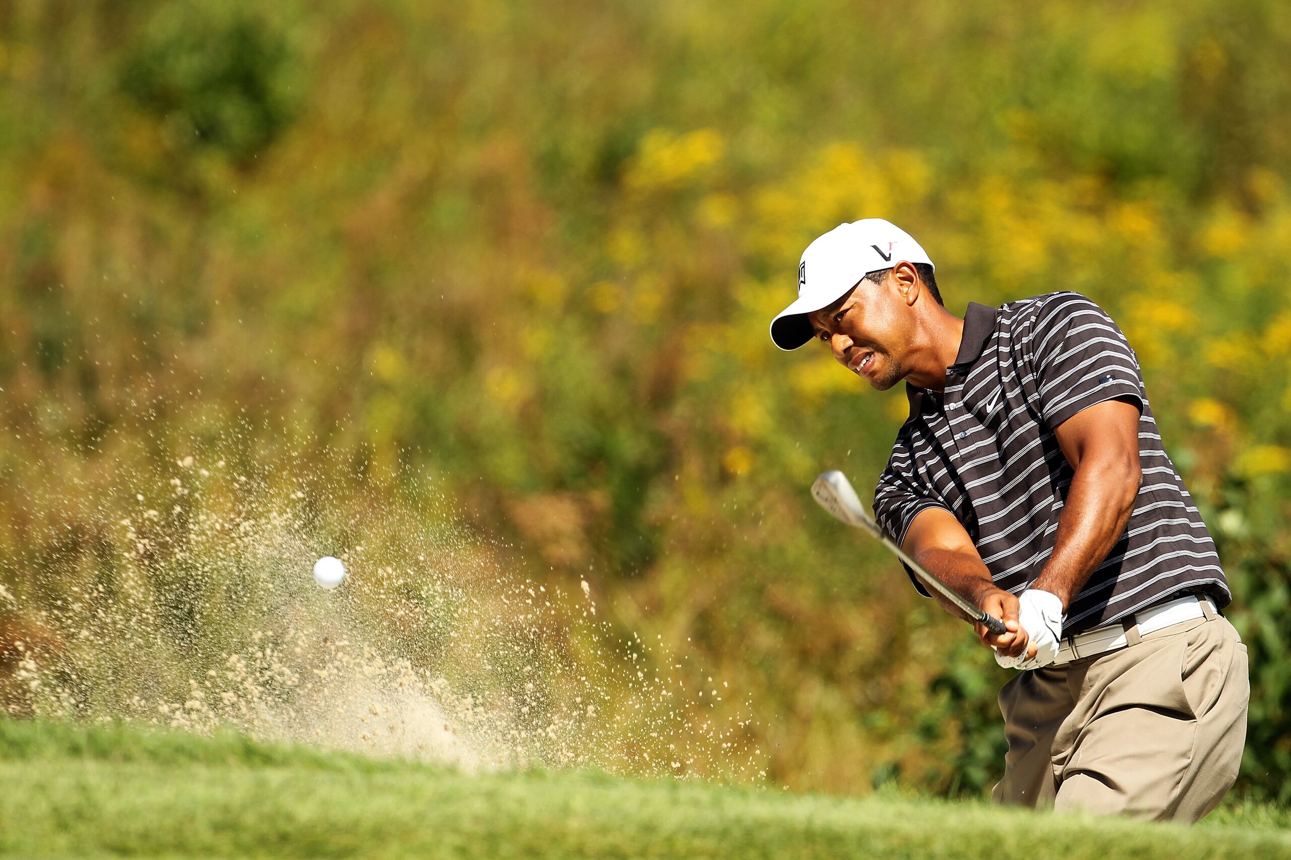 NORTON, MA - SEPTEMBER 05:  Tiger Woods hits a shot out of the bunker on the third hole during the third round of the Deutsche Bank Championship at TPC Boston on September 5, 2010 in Norton, Massachusetts.  (Photo by Mike Ehrmann/Getty Images)