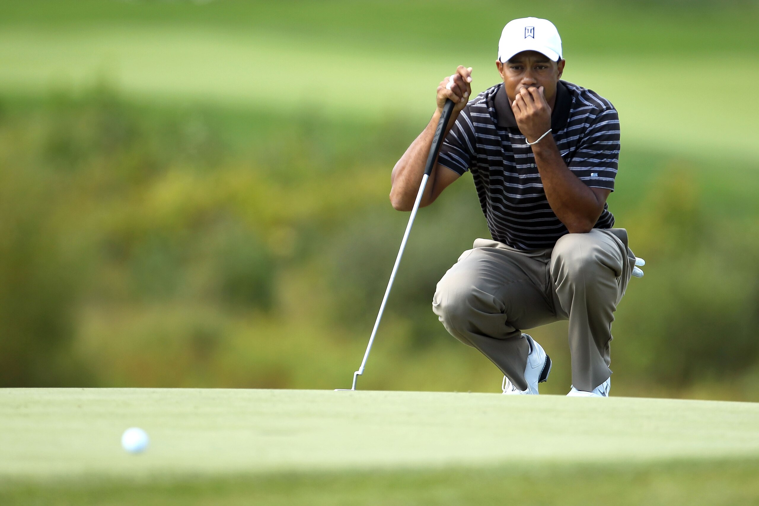 NORTON, MA - SEPTEMBER 05:  Tiger Woods lines up a putt on the second green during the third round of the Deutsche Bank Championship at TPC Boston on September 5, 2010 in Norton, Massachusetts.  (Photo by Mike Ehrmann/Getty Images)