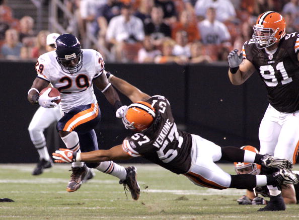 CLEVELAND - SEPTEMBER 2:  Chester Taylor #29  of the Chicago Bears carries the ball up as David Veikune #57 of the Cleveland Browns attempts the tackle during the preseason game on September 2, 2010 at Cleveland Browns Stadium in Cleveland, Ohio. (Photo b