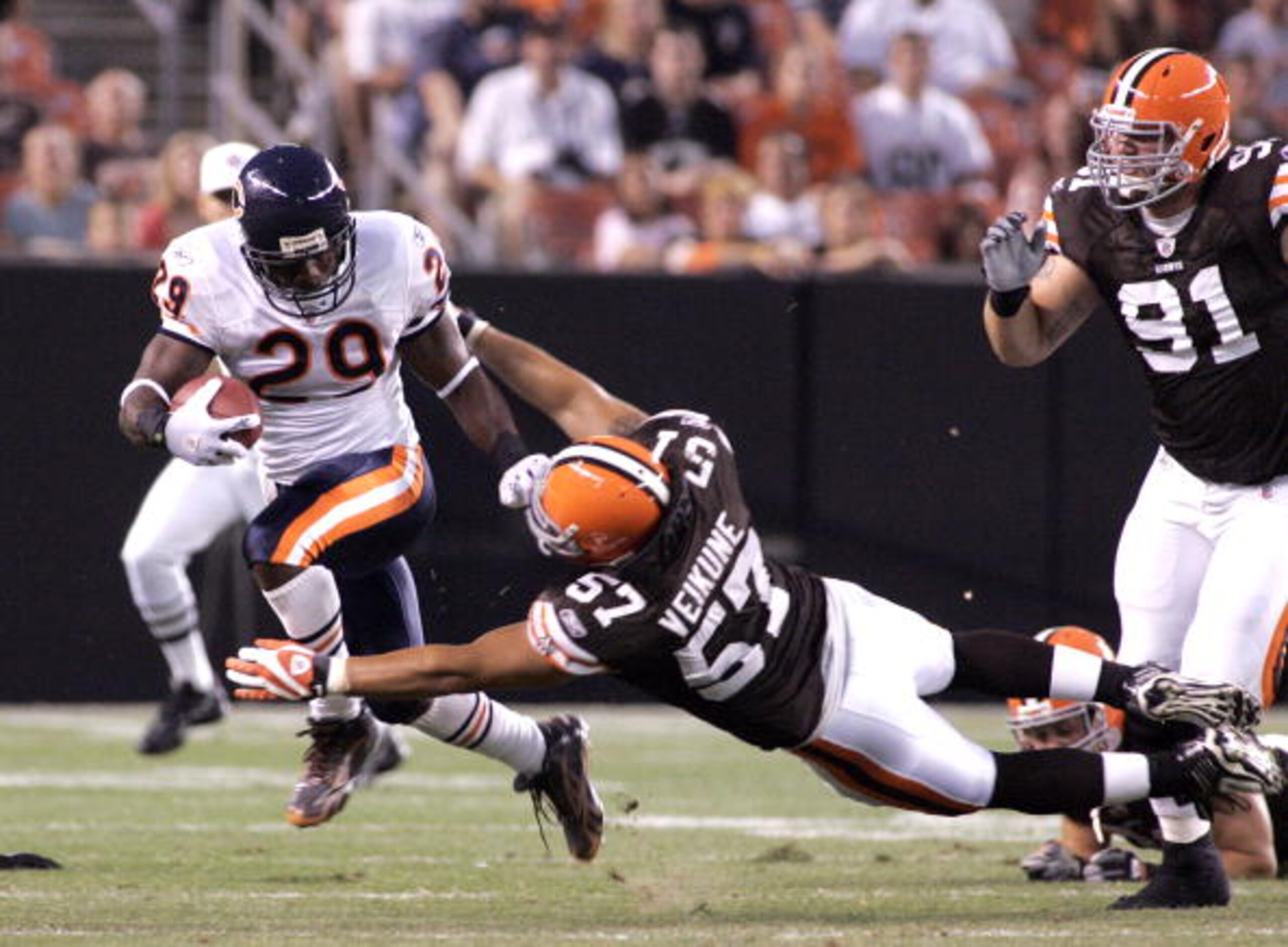 CLEVELAND - SEPTEMBER 2:  Chester Taylor #29  of the Chicago Bears carries the ball up as David Veikune #57 of the Cleveland Browns attempts the tackle during the preseason game on September 2, 2010 at Cleveland Browns Stadium in Cleveland, Ohio. (Photo b