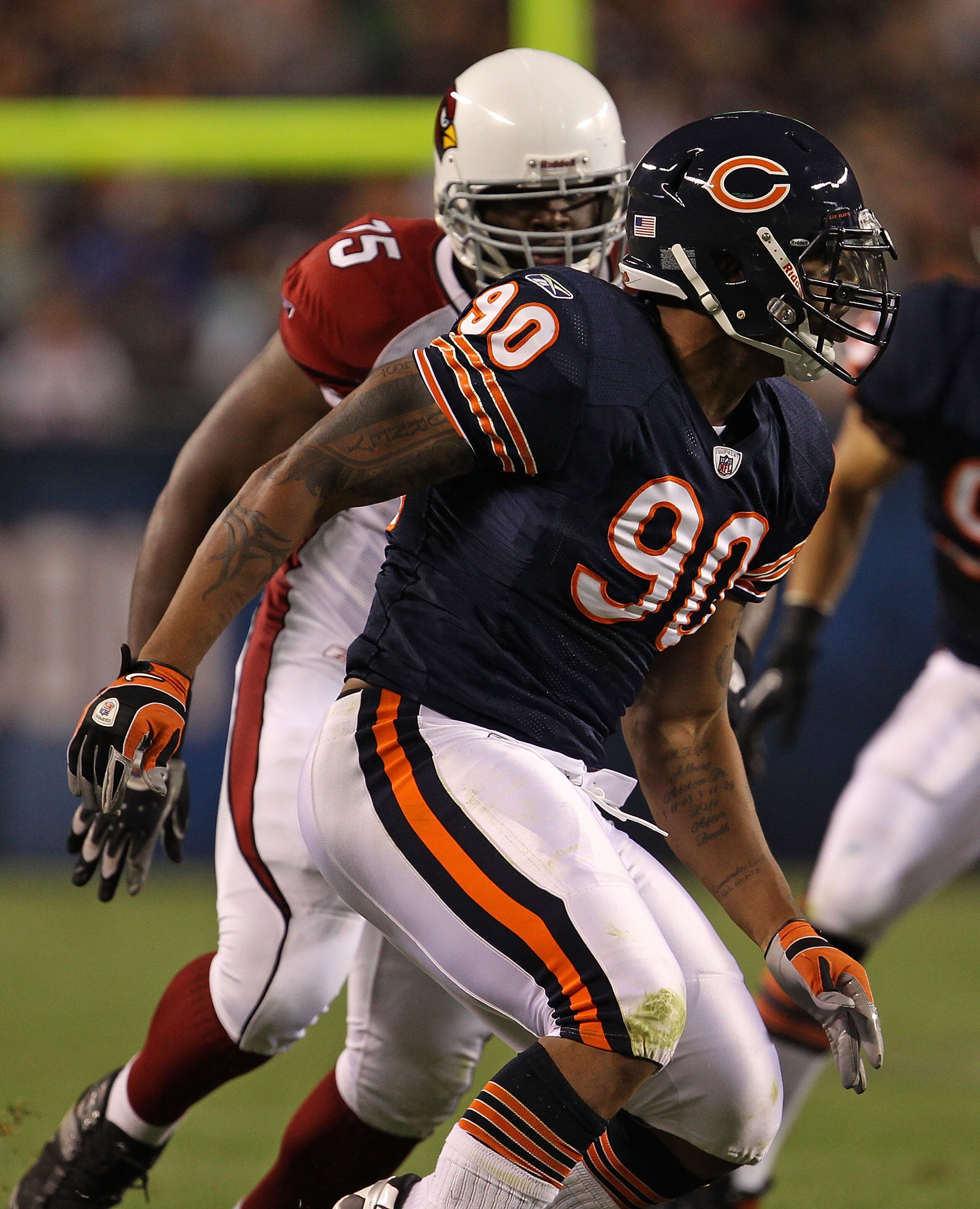 CHICAGO - AUGUST 28: Julius Peppers #90 of the Chicago Bears rushes past Levi Brown #75 of the Arizona Cardinals during a preseason game at Soldier Field on August 28, 2010 in Chicago, Illinois. The Cardinals defeated the Bears 14-9. (Photo by Jonathan Da