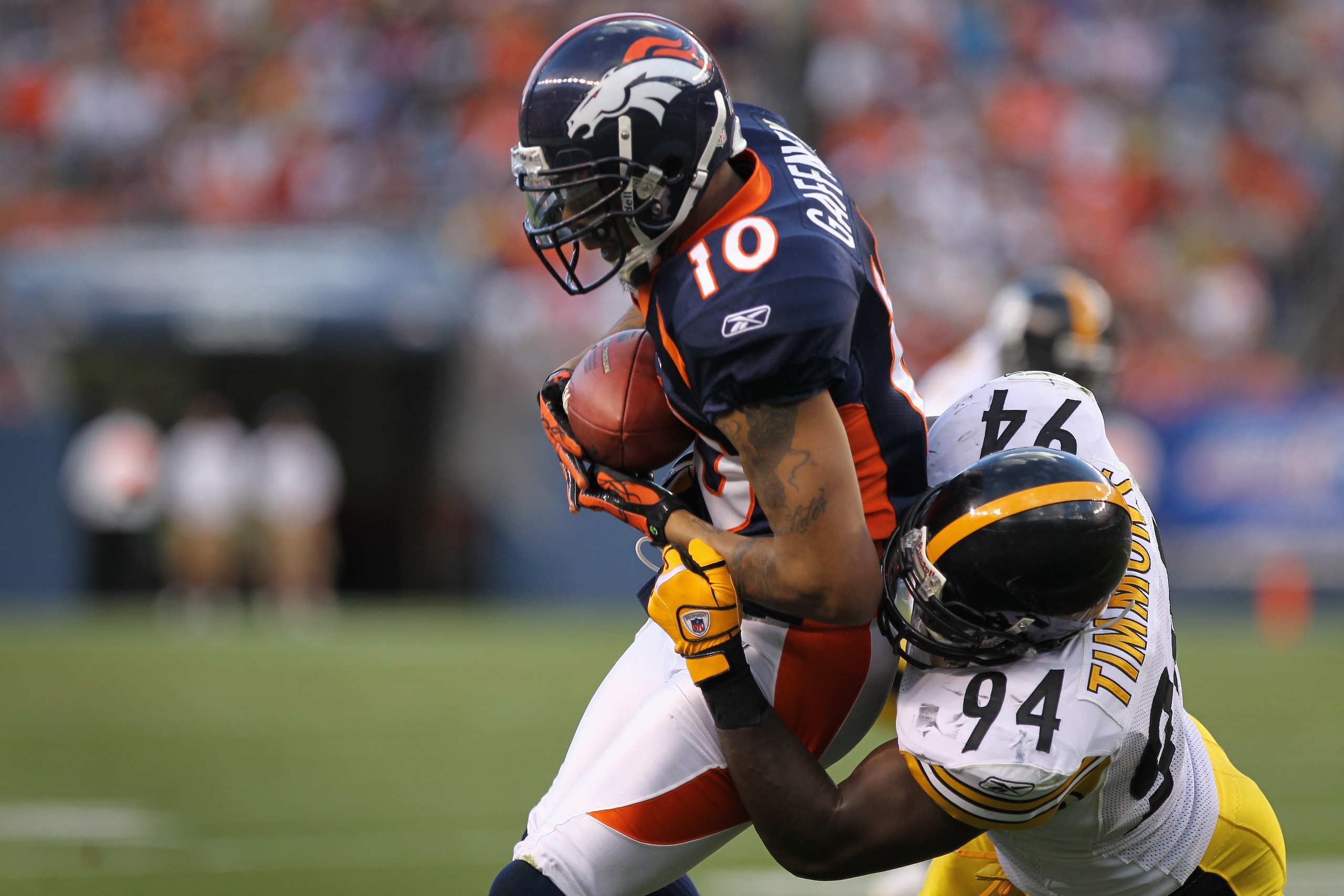 DENVER - AUGUST 29:  Wide receiver Jabar Gaffney #10 of the Denver Broncos makes a reception and is tackled by linebacker Lawrence Timmons #94 of the Pittsburgh Steelers during preseason NFL action at INVESCO Field at Mile High on August 29, 2010 in Denve