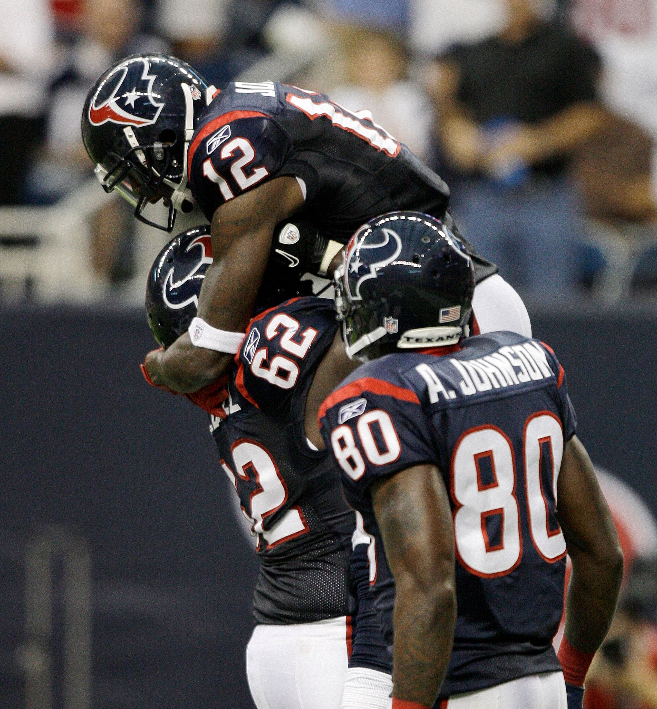 HOUSTON - AUGUST 28:  Wide receiver Jacoby Jones #12 of the Houston Texans celebrates his touchdown reception with Antoine Caldwell #62 and Andre Johnson #80 in the first quarter against the Dallas Cowboys in a preseason game at Reliant Stadium on August 