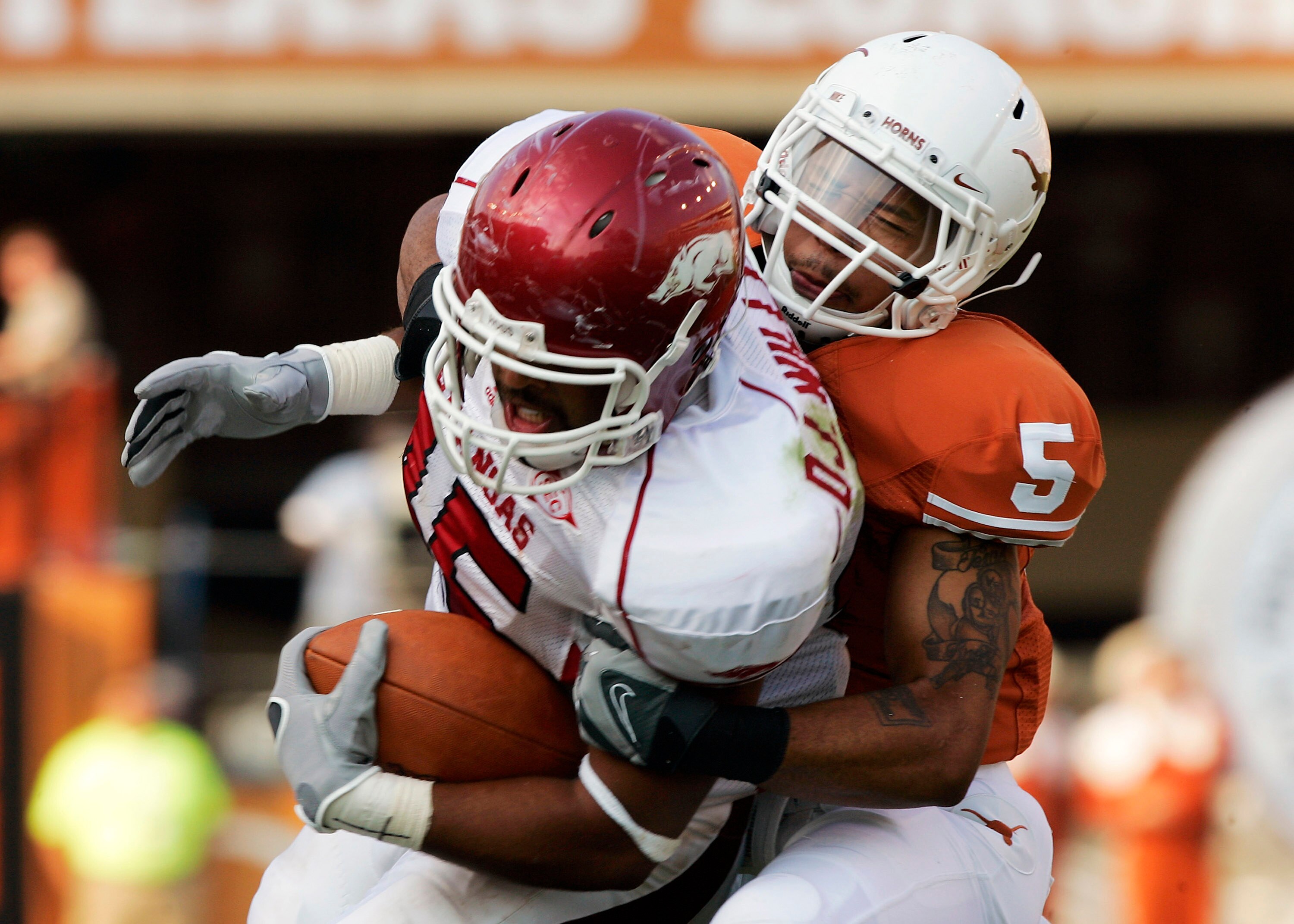 AUSTIN, TX - SEPTEMBER 27:  Safety Ben Wells #5 of the Texas Longhorns wrestles tight end D.J. Williams #45 of the Arkansas Razorbacks in the fourth quarter on September 27, 2008 at Darrell K Royal-Texas Memorial Stadium in Austin, Texas.  Texas won 52-10