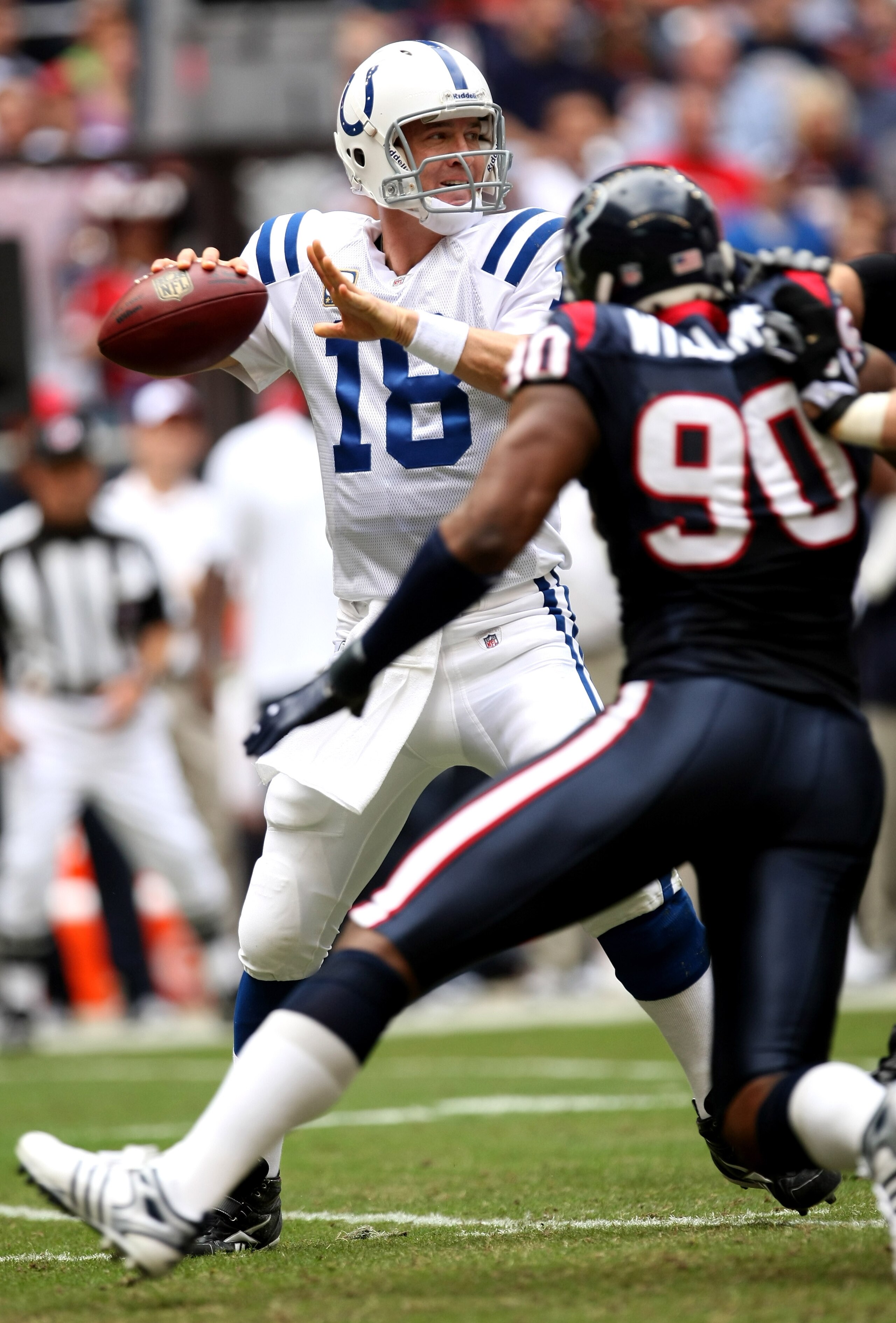 HOUSTON - NOVEMBER 29: Quarterback Peyton Manning #18 of the Indianapolis Colts throws a pass as defensive end Mario Williams #90 of the Houston Texans rushes on November 29, 2009 at Reliant Stadium in Houston, Texas.  (Photo by Stephen Dunn/Getty Images)