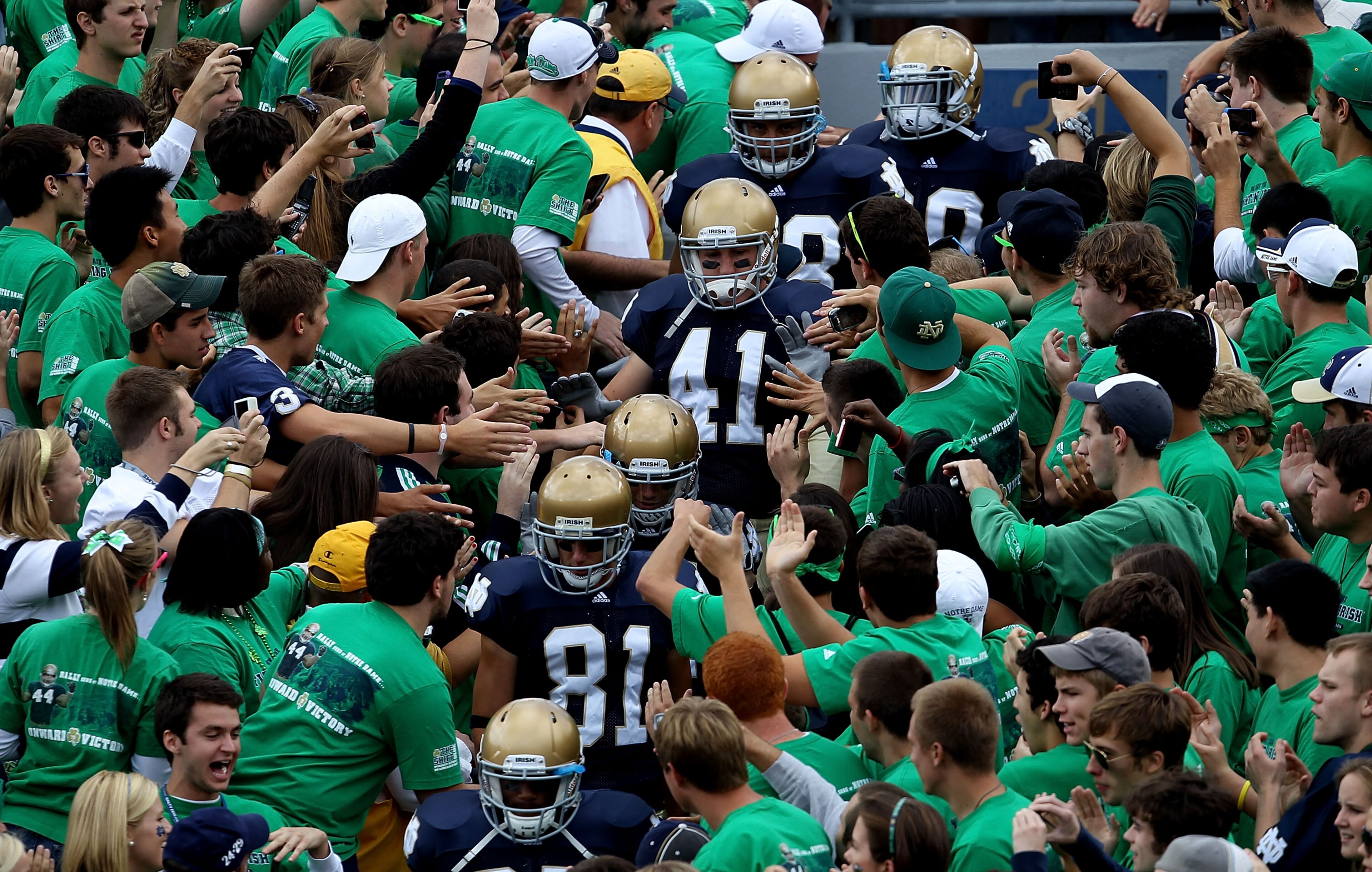 SOUTH BEND, IN - SEPTEMBER 04: Players from the Notre Dame Fighting Irish walk to the field through the student section for warm-ups before a game against the Purdue Boilermakers at Notre Dame Stadium on September 4, 2010 in South Bend, Indiana. Notre Dam