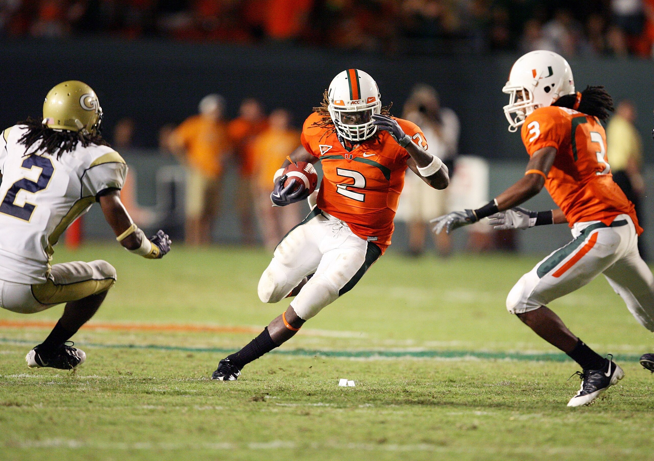 FORT LAUDERDALE, FL - SEPTEMBER 17:  Running back Graig Cooper #2 of the Miami Hurricanes looks to avoid being brought down by cornerback Mario Butler #2 of the Georgia Tech Yellow Jackets at Land Shark Stadium on September 17, 2009 in Fort Lauderdale, Fl