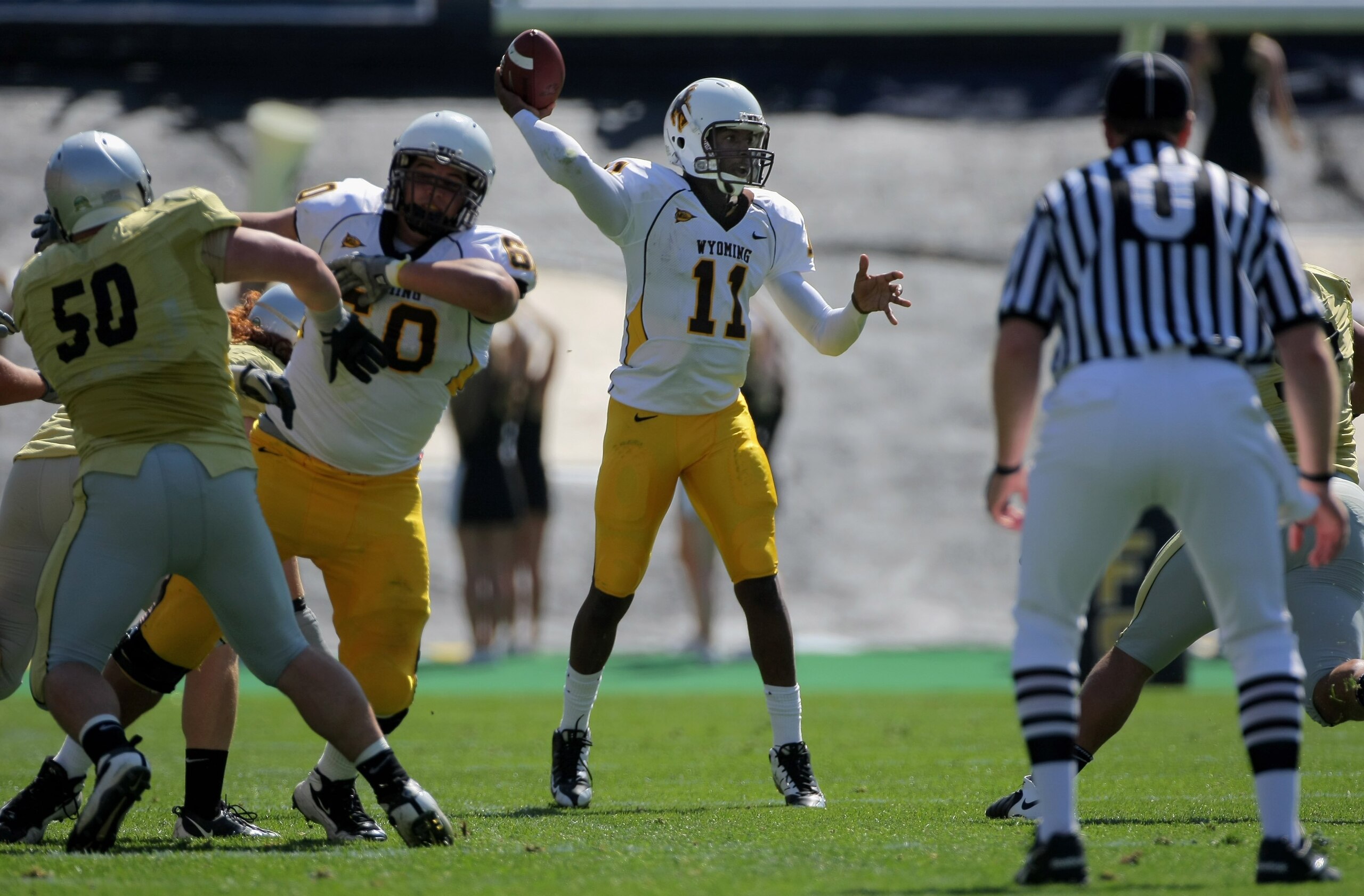 BOULDER, CO - SEPTEMBER 19:  Quarterback Robert Benjamin #11 of the Wyoming Cowboys delivers a pass against the Colorado Buffaloes at Folsom Field on September 19, 2009 in Boulder, Colorado. The Buffaloes defeated the Cowboys 24-0.  (Photo by Doug Pensing