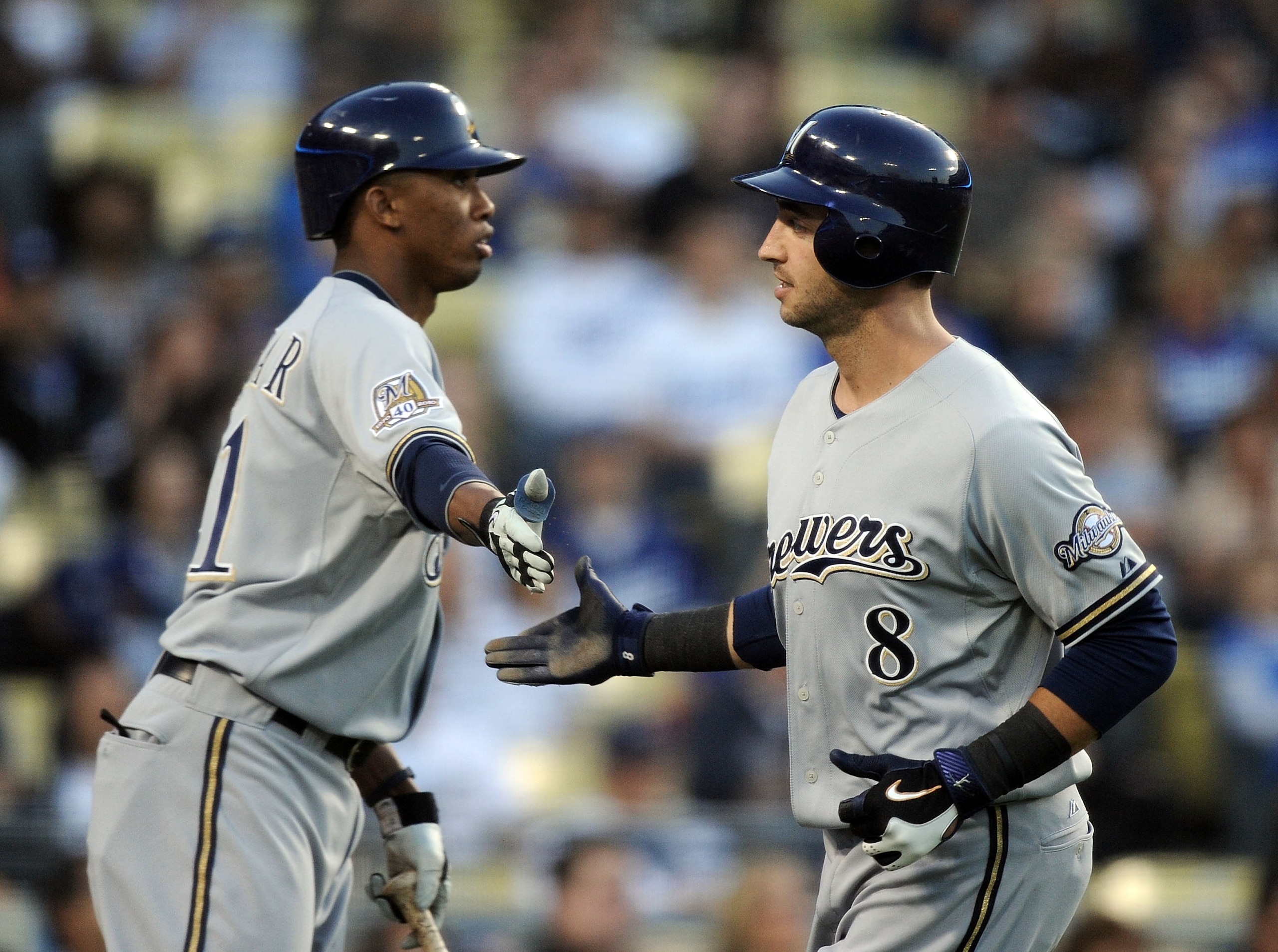 LOS ANGELES, CA - MAY 05:  Ryan Braun #8 of the Milwaukee Brewers celebrates his run off a wild pitch with Alcides Escobar #21 against the Los Angeles Dodgers during the first inning at Dodger Stadium on May 5, 2010 in Los Angeles, California.  (Photo by