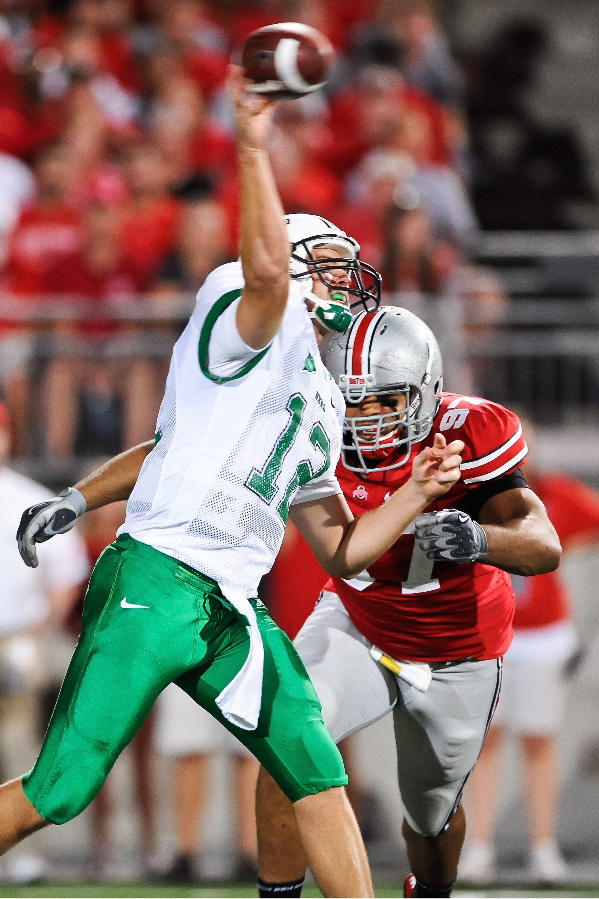 COLUMBUS, OH - SEPTEMBER 2: Quarterback Brian Anderson #12 of the Marshall Thundering Herd passes as Cameron Heyward #97 of the Ohio State Buckeyes closes in at Ohio Stadium on September 2, 2010 in Columbus, Ohio. (Photo by Jamie Sabau/Getty Images)