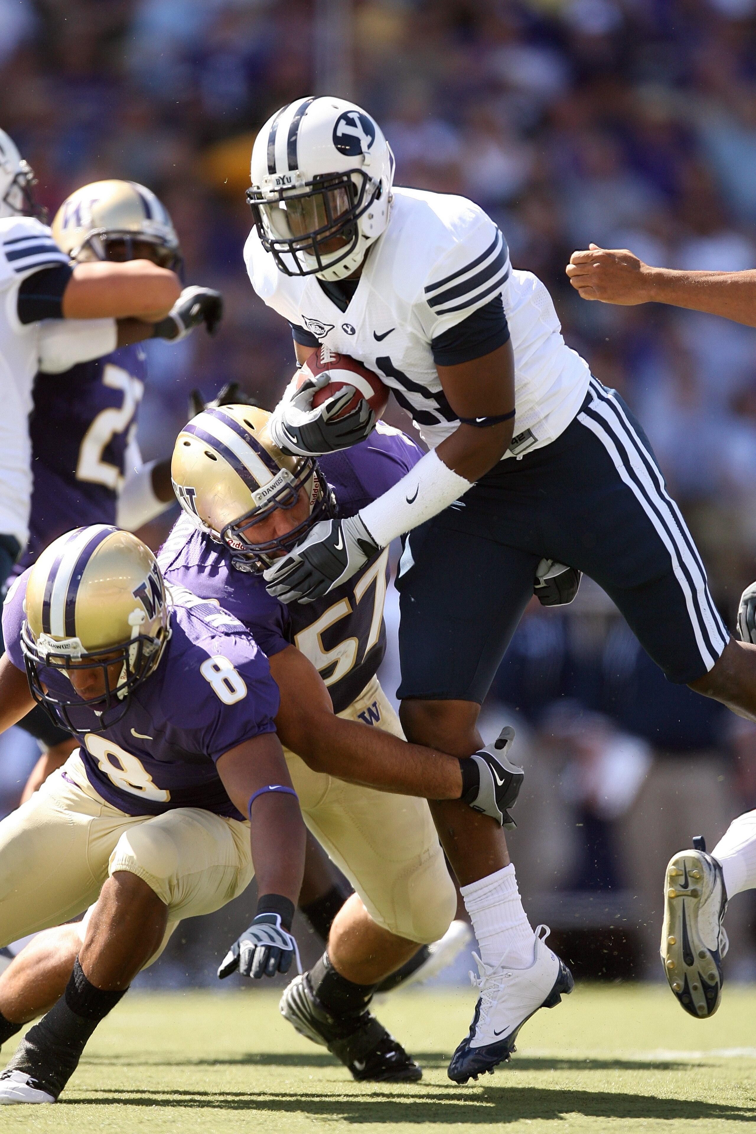 SEATTLE - SEPTEMBER 6:  Trenton Tuiasosopo #57 of the Washington Huskies tackles O'Neill Chambers #11 of the BYU Cougars during the game on September 6, 2008 at Husky Stadium in Seattle, Washington. The Cougars defeated the Huskies 28-27. (Photo by Otto G