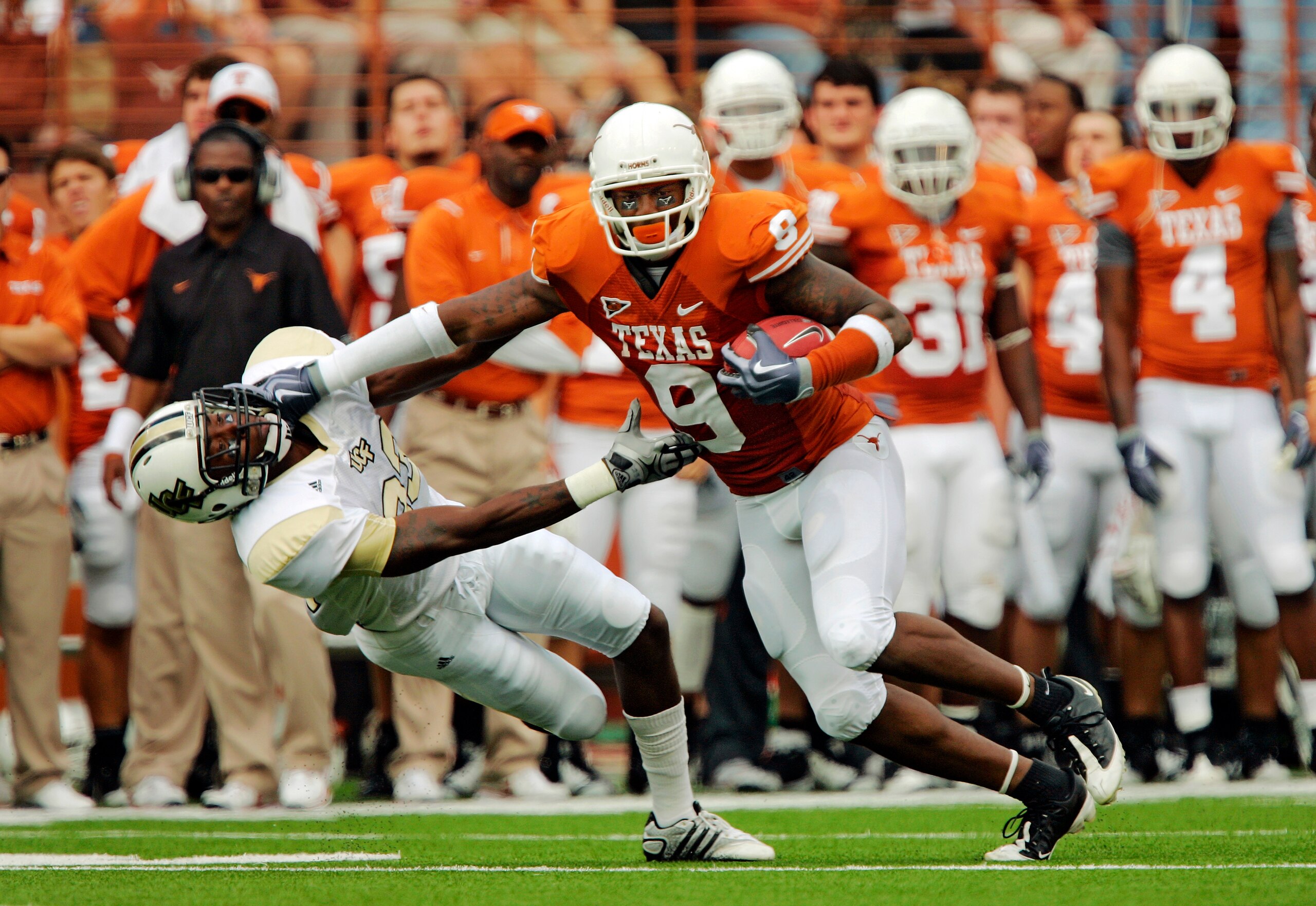 AUSTIN, TX - NOVEMBER 07:  Wide receiver Malcolm Williams #9 of the Texas Longhorns stiff arms cornerback Justin Boddie #23 of the UCF Knights in the second quarter on November 7, 2009 at Darrell K Royal - Texas Memorial Stadium in Austin, Texas.  Texas w