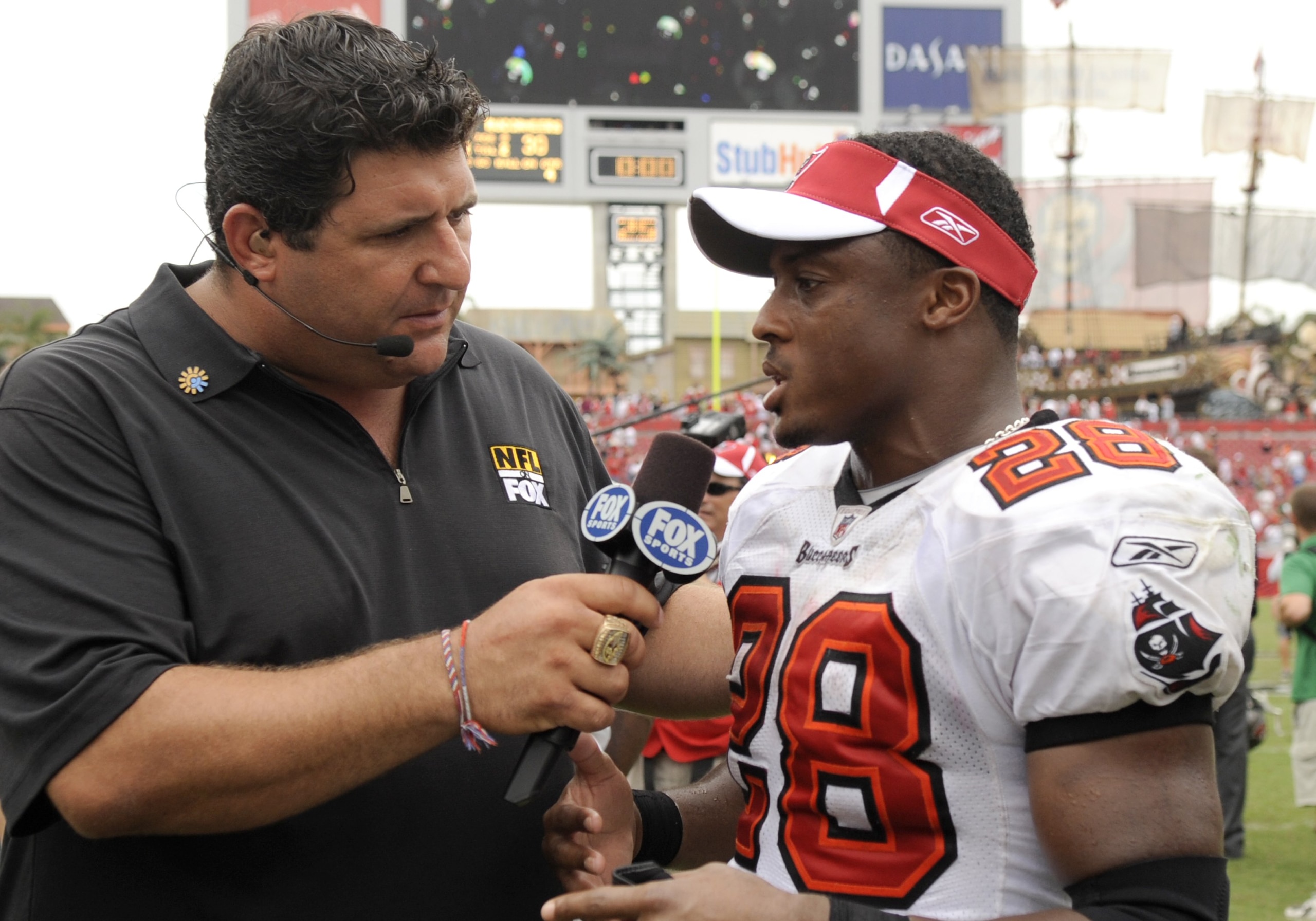 TAMPA, FL - SEPTEMBER 28: Running back Warrick Dunn #28 of  the Tampa Bay Buccaneers talks with FOX television commentator Tony Siragusa after play against the Green Bay Packers at Raymond James Stadium on September 28, 2008 in Tampa, Florida.  (Photo by 