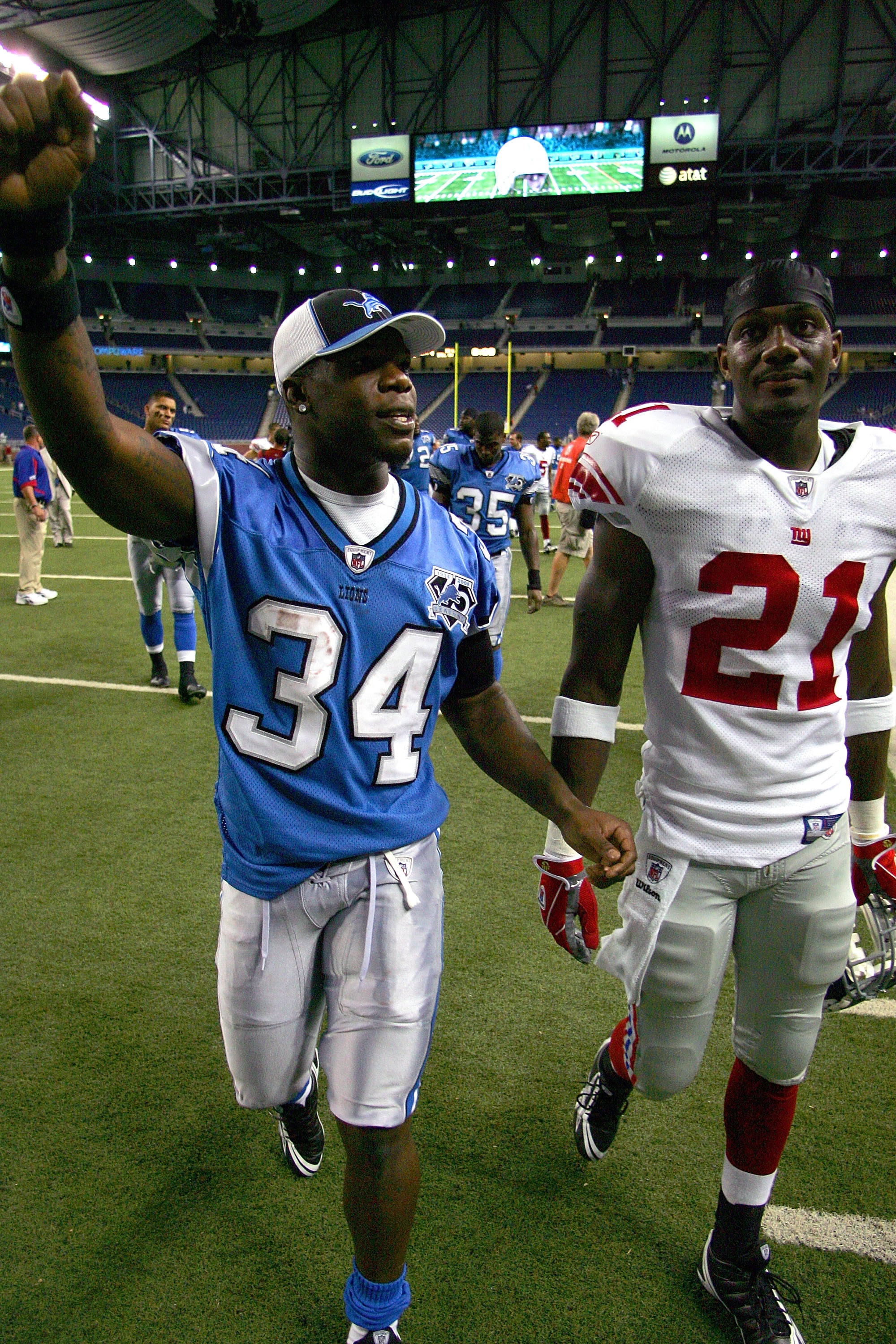 DETROIT , MI - AUGUST 07: Rookies Kevin Smith #34 of the Detroit Lions and Kenny Phillips #21 of the New York Giants walk off the field together after a preseason game on August 7, 2008 at Ford Field in Detroit, Michigan. (Photo by Domenic Centofanti/Ge DETROIT , MI - AUGUST 07: Rookies Kevin Smith #34 of the Detroit Lions and Kenny Phillips #21 of the New York Giants walk off the field together after a preseason game on August 7, 2008 at Ford Field in Detroit, Michigan. (Photo by Domenic Centofanti/Ge