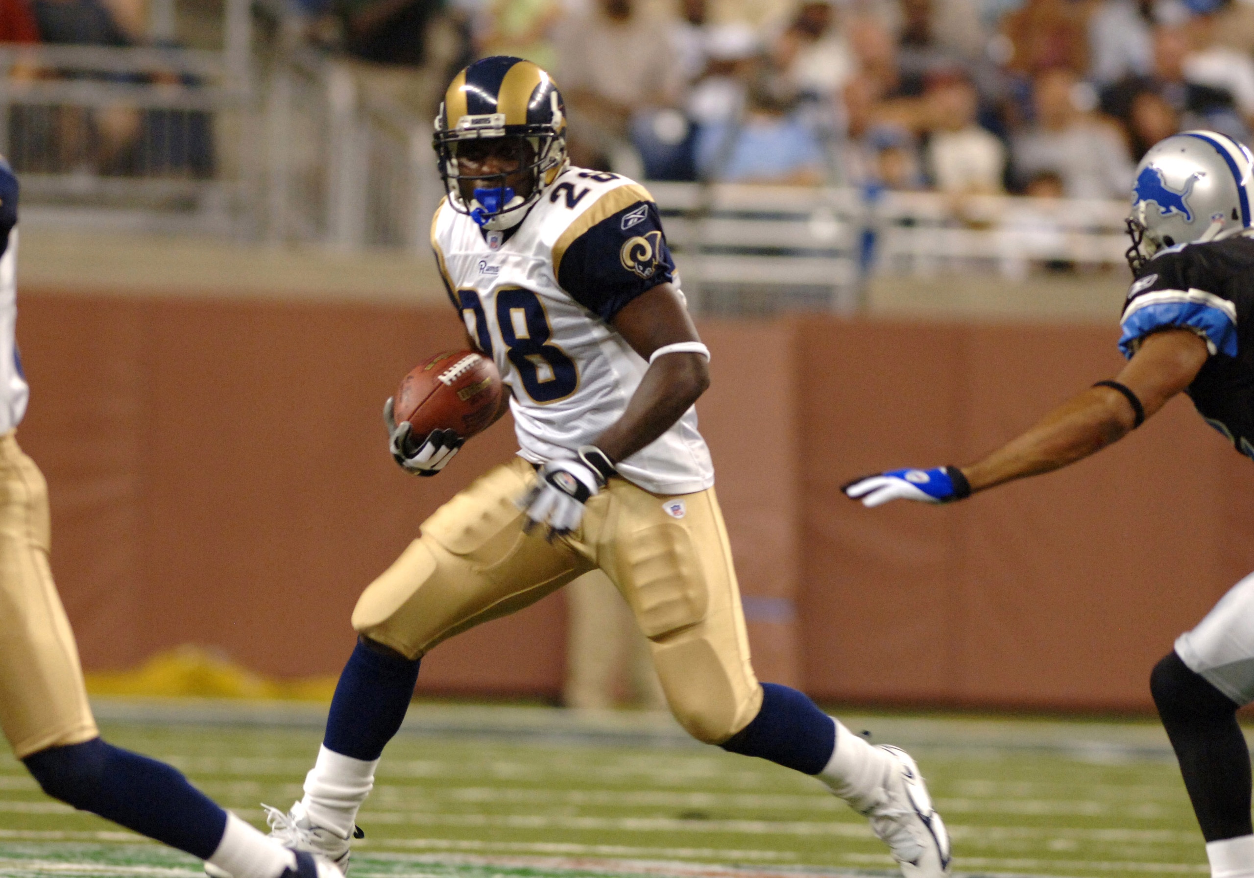 St. Louis Rams running back Marshall Faulk  rushes upfield   against  the Detroit Lions in a pre-season game on August 29, 2005 at Ford Field, in Detroit, Michigan.  (Photo by Al Messerschmidt/Getty Images)