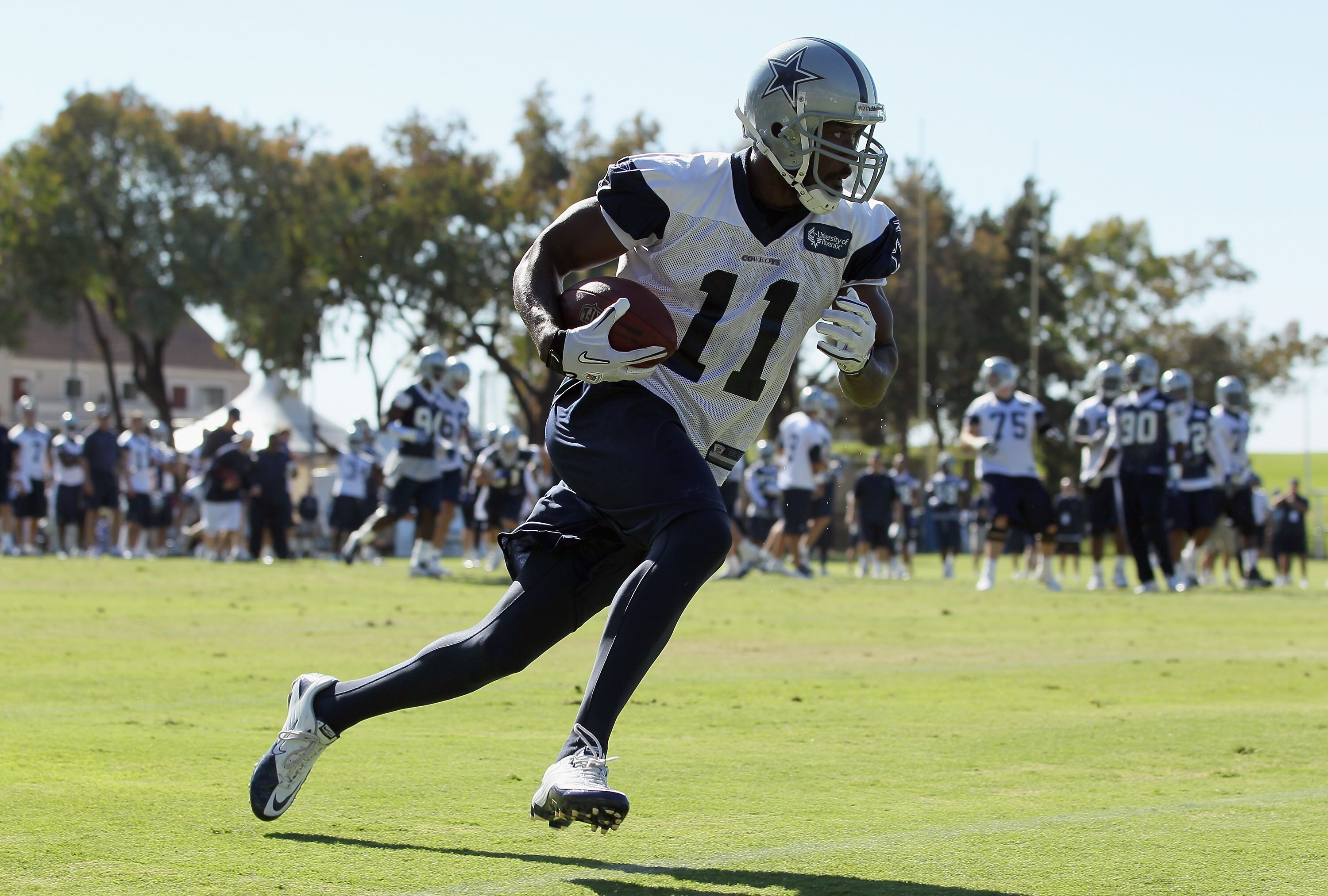 OXNARD, CA - AUGUST 14:  Wide receiver Roy Williams #11 carries the ball during Dallas Cowboys Training Camp at the Marriott Residence Inn Oxnard River Ridge on August 14, 2010 in Oxnard, California.  (Photo by Jeff Gross/Getty Images)
