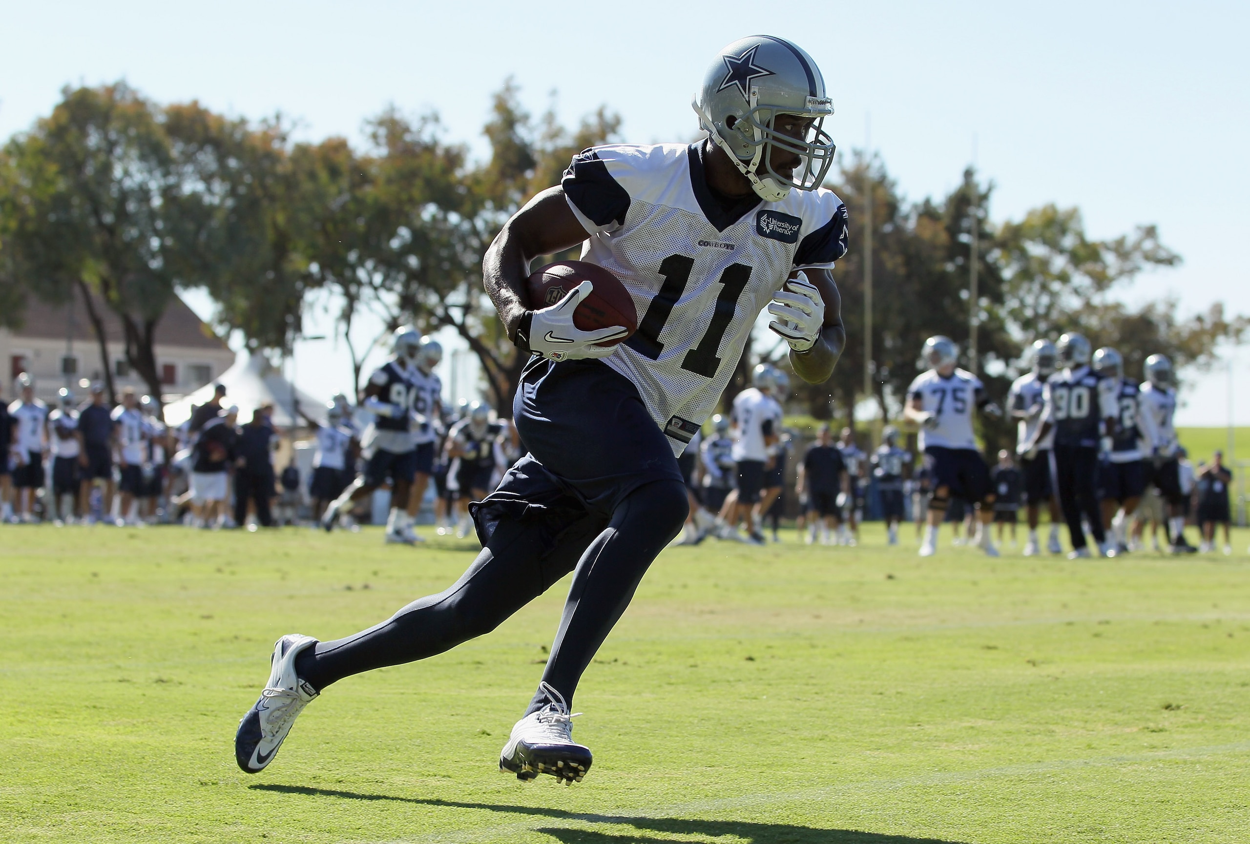 OXNARD, CA - AUGUST 14:  Wide receiver Roy Williams #11 carries the ball during Dallas Cowboys Training Camp at the Marriott Residence Inn Oxnard River Ridge on August 14, 2010 in Oxnard, California.  (Photo by Jeff Gross/Getty Images)