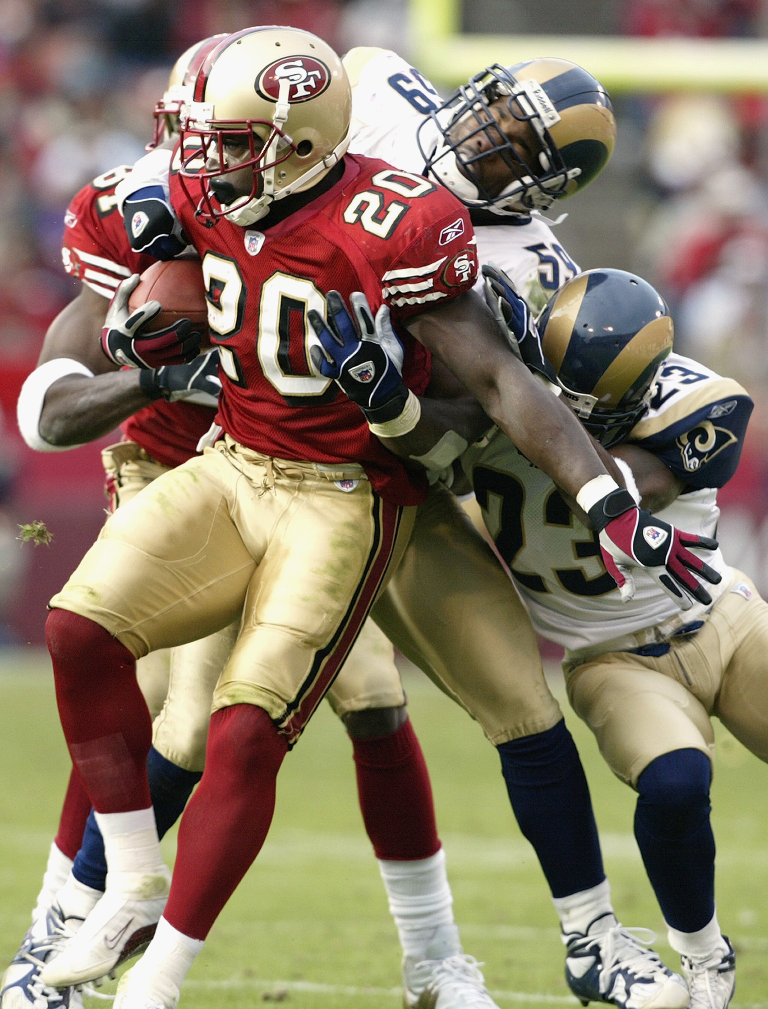 SAN FRANCISCO - NOVEMBER 2:  Running back Garrison Hearst #20 of the San Francisco 49ers is tackled by linebacker Jamie Duncan #59 and cornerback Jerametrius Butler #23 of the St. Louis Rams during the game at Candlestick Park on November 2, 2003 in San F