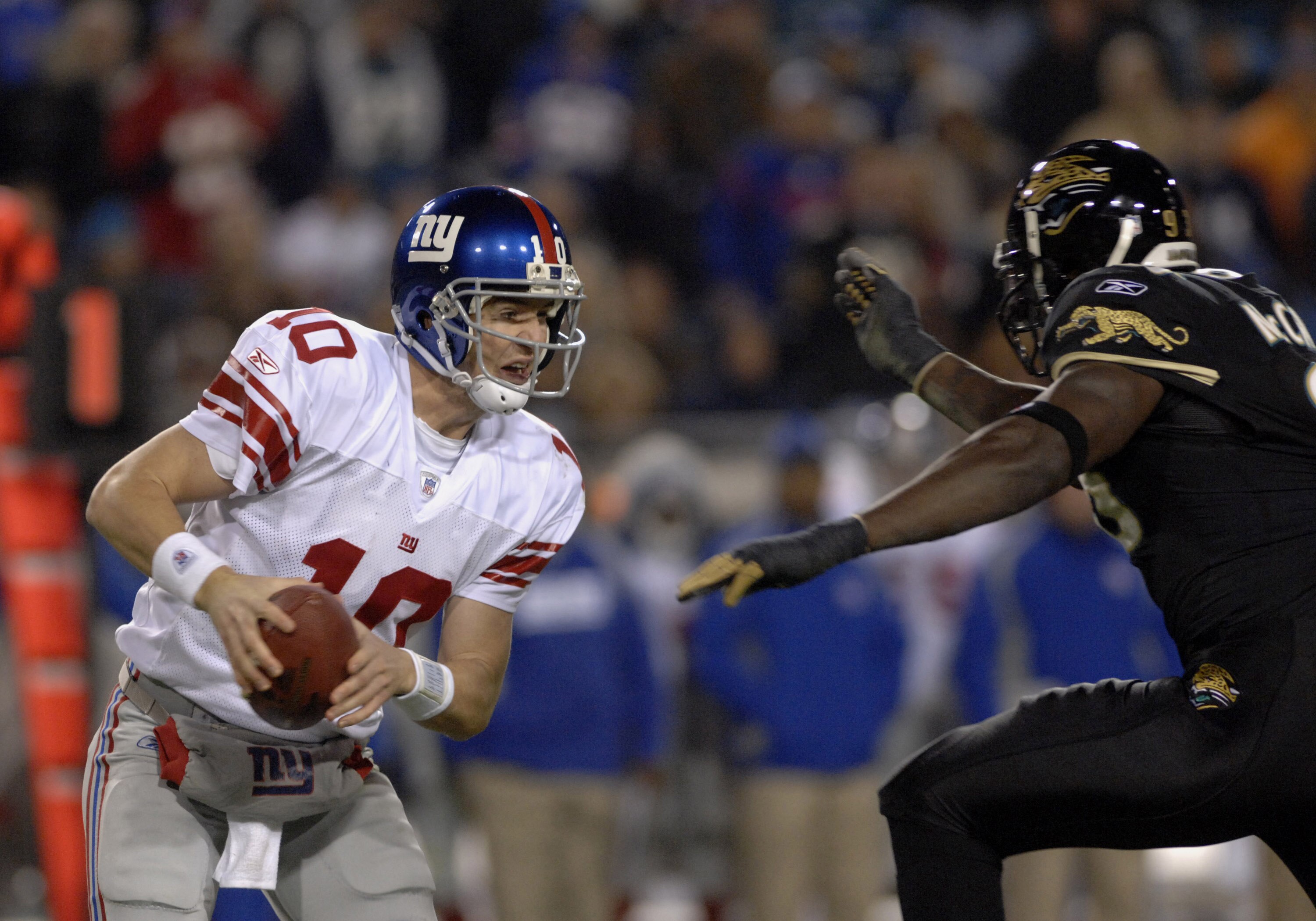 New York Giants quarterback Eli Manning dodges the pass rush of the Jacksonville Jaguars on ESPN Monday Night Football Nov. 20, 2006 in Jacksonville. The Jaguars won 26 - 10. (Photo by Al Messerschmidt/Getty Images) New York Giants quarterback Eli Manning dodges the pass rush of the Jacksonville Jaguars on ESPN Monday Night Football Nov. 20, 2006 in Jacksonville. The Jaguars won 26 - 10. (Photo by Al Messerschmidt/Getty Images)