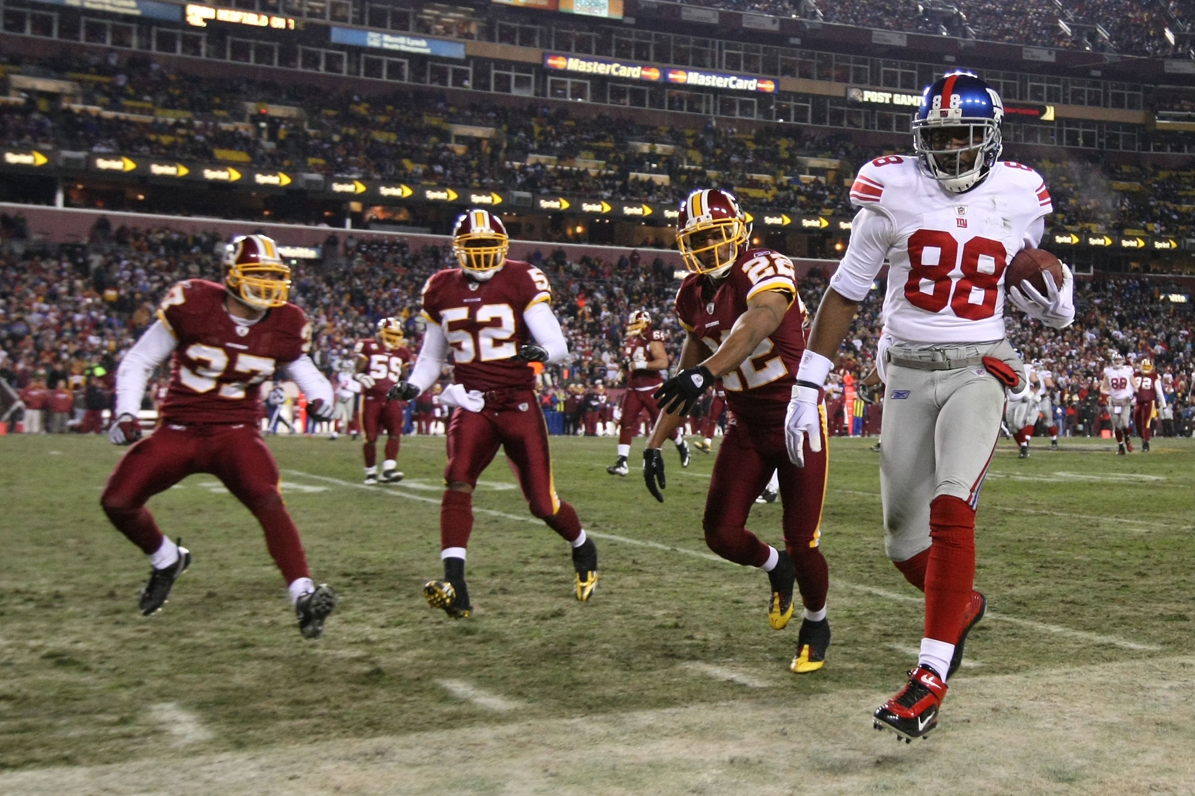 LANDOVER, MD - DECEMBER 21: Hakeem Nicks #88 of the New York Giants in action against Carlos Rogers #22, Rocky McIntosh #52, and Reed Doughty #37 of the Washington Redskins during their game on December 21, 2009 at Fedex Field in Landover, Maryland. (Ph LANDOVER, MD - DECEMBER 21: Hakeem Nicks #88 of the New York Giants in action against Carlos Rogers #22, Rocky McIntosh #52, and Reed Doughty #37 of the Washington Redskins during their game on December 21, 2009 at Fedex Field in Landover, Maryland. (Ph