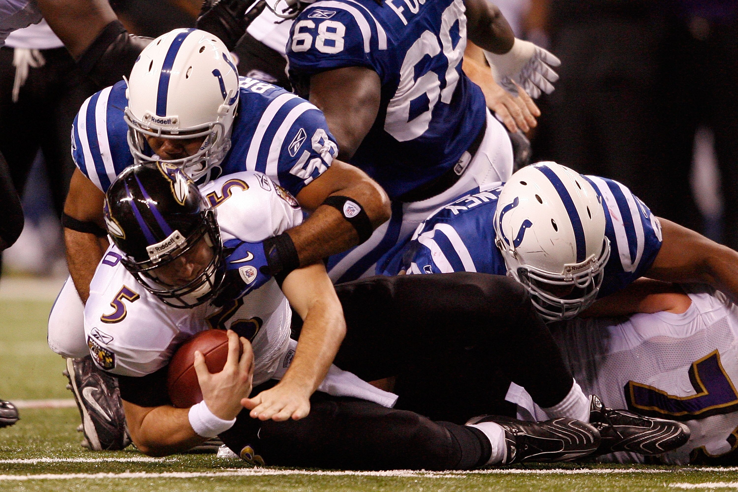 INDIANAPOLIS - JANUARY 16:  Gary Brackett #58 of the Indianapolis Colts sacks quarterback Joe Flacco #5 of the Baltimore Ravens for a six-yard loss in the second quarter of the AFC Divisional Playoff Game at Lucas Oli Stadium on January 16, 2010 in Indian