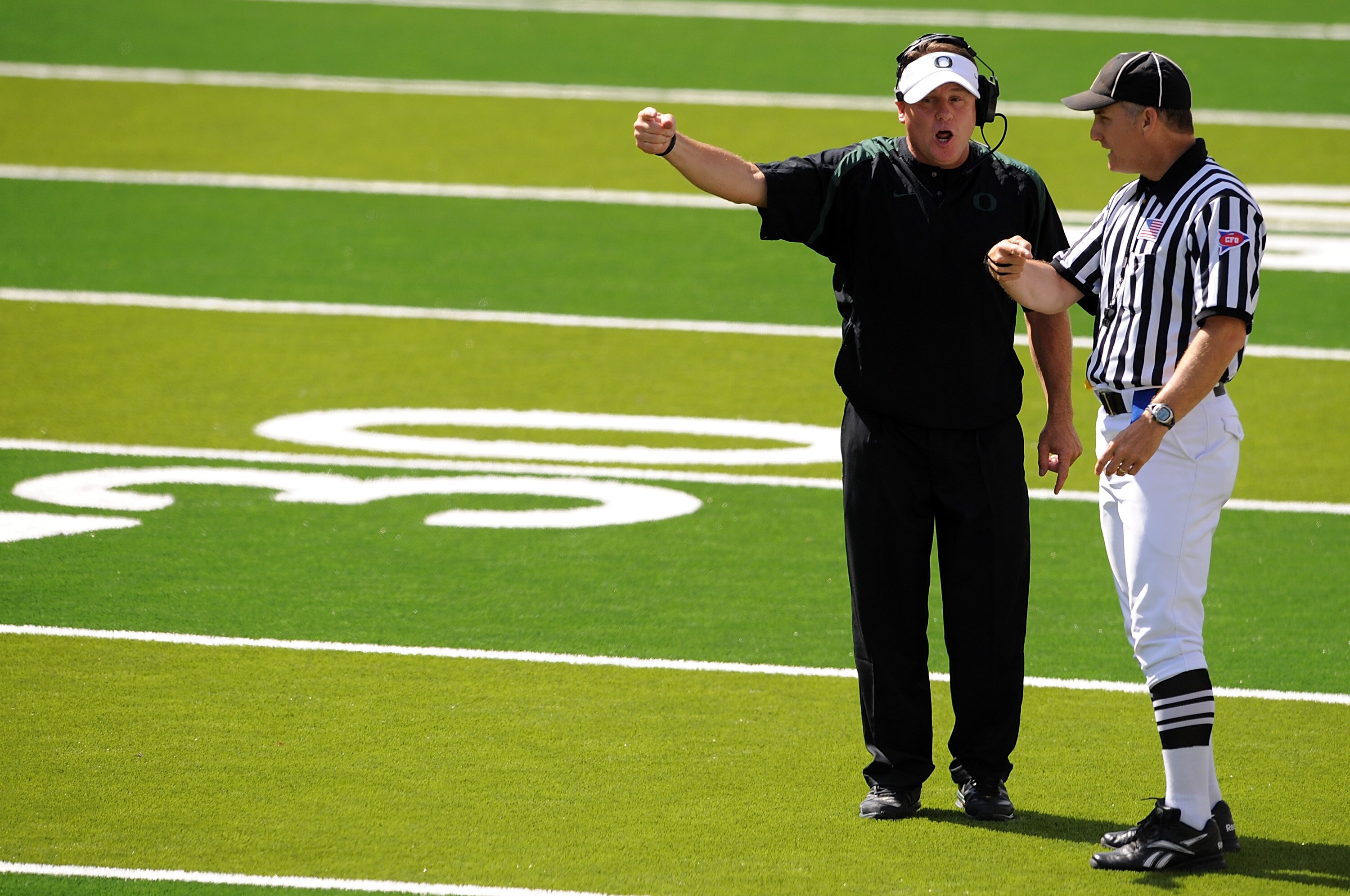 EUGENE, OR - SEPTEMBER 04: Head coach Chip Kelly of the Oregon Ducks has some words with side judge Bernie Hulscher in the third quarter of the game against the New Mexico Lobos at Autzen Stadium on September 4, 2010 in Eugene, Oregon. Oregon won the game