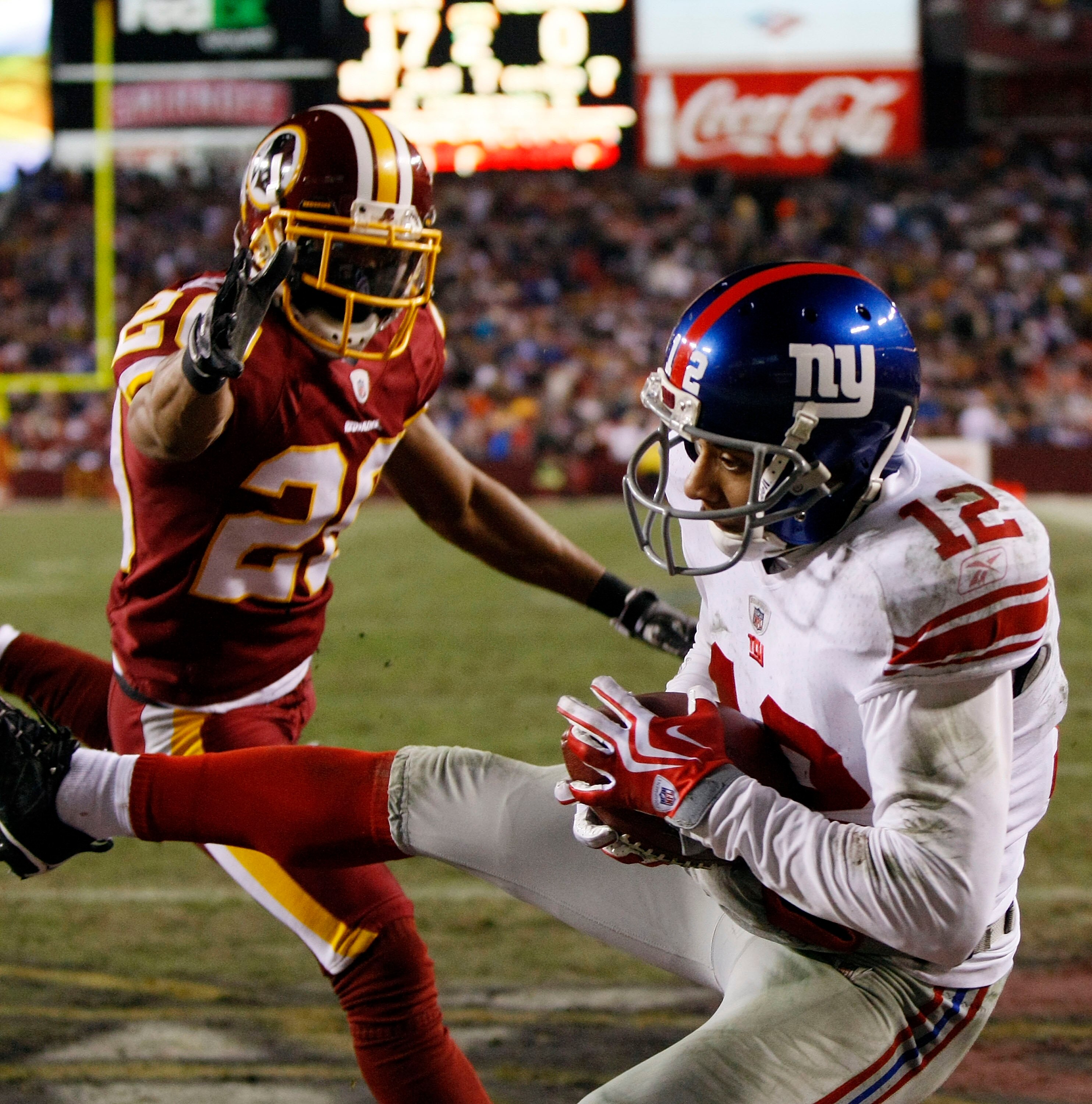 LANDOVER, MD - DECEMBER 21: Wide receiver Steve Smith #12 of the New York Giants catches a pass for a touchdown against Justin Tryon #20 the Washington Redskins at FedEx Field on December 21, 2009 in Landover, Maryland. The Giants won the game 45-12. (P LANDOVER, MD - DECEMBER 21: Wide receiver Steve Smith #12 of the New York Giants catches a pass for a touchdown against Justin Tryon #20 the Washington Redskins at FedEx Field on December 21, 2009 in Landover, Maryland. The Giants won the game 45-12. (P