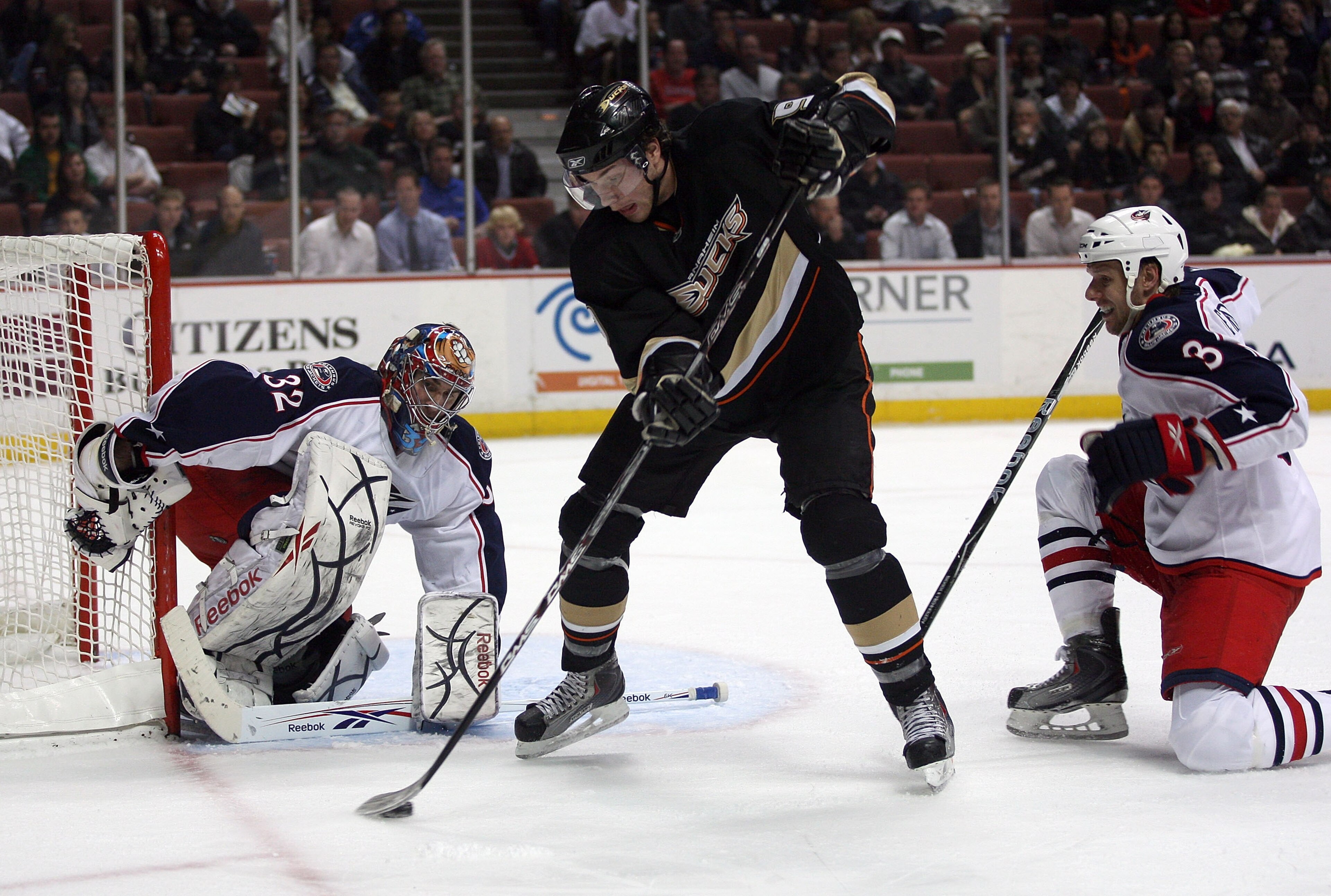 ANAHEIM, CA - MARCH 09:  Goaltender Mathieu Garon #32 of the Columbus Blue Jackets defends his net as Bobby Ryan #9 of the Anaheim Ducks makes a backhand pass between his legs into the middle slow area past Marc Methot #3 of the Columbus Blue Jackets in t
