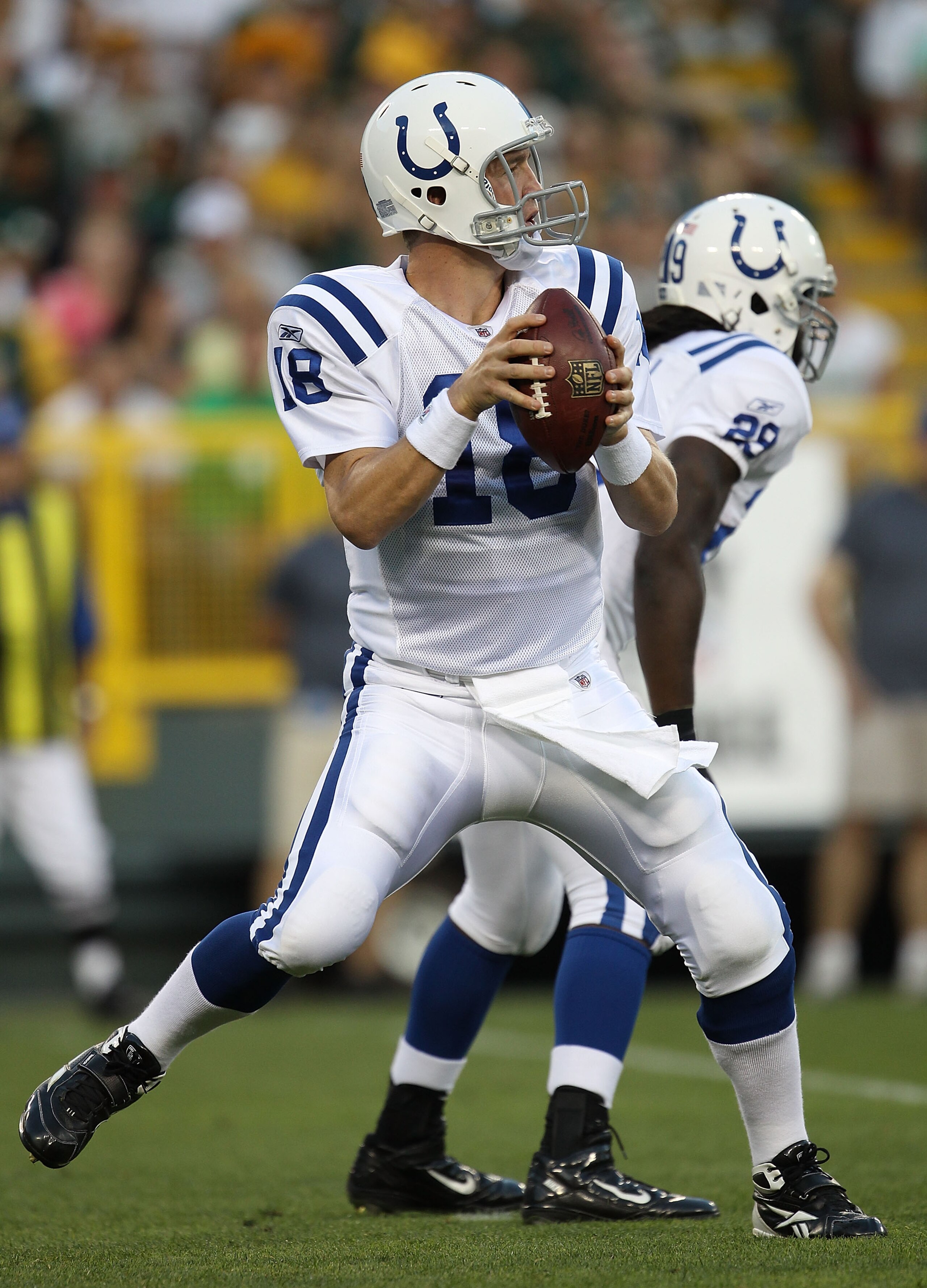 GREEN BAY, WI - AUGUST 26: Peyton Manning #18 of the Indianapolis Colts drops back to pass against the Green Bay Packers during a preseason game at Lambeau Field on August 26, 2010 in Green Bay, Wisconsin.  The Packers defeated the Colts 59-24.  (Photo by