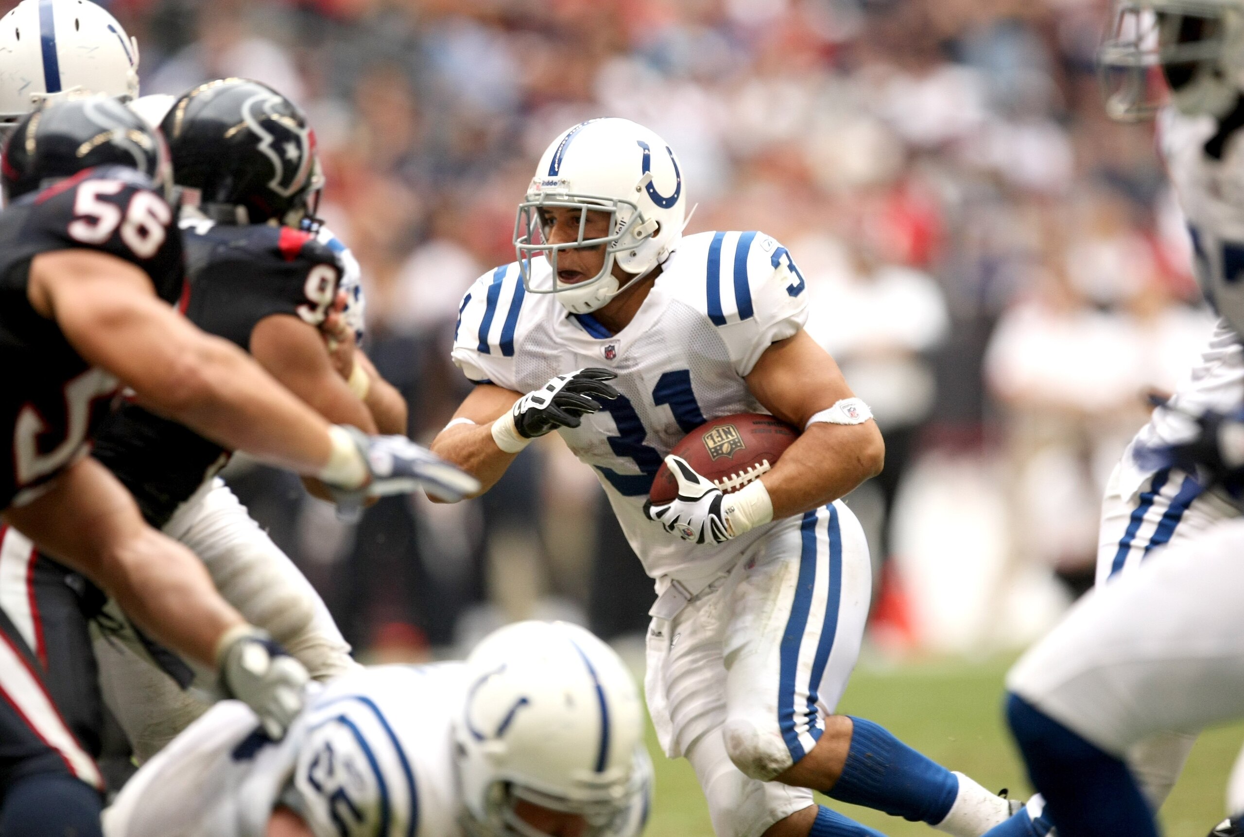 HOUSTON - NOVEMBER 29:  Running back Donald Brown #31 of the Indianapolis Colts rushes against linebacker Brian Cushing #56 of the Houston Texans on November 29, 2009  at Reliant Stadium in Houston, Texas. The Colts won 35-27.  (Photo by Stephen Dunn/Gett