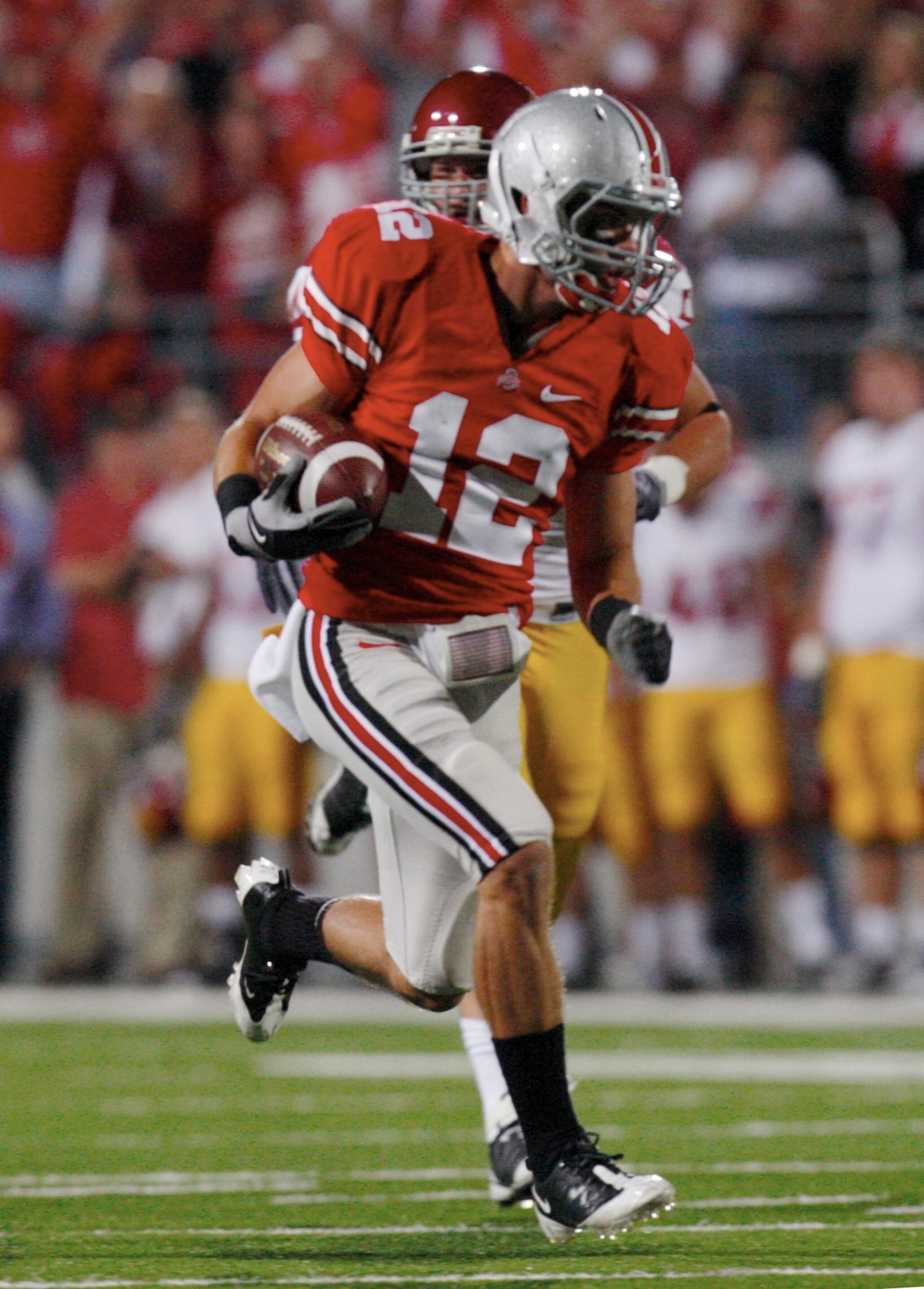 COLUMBUS, OH - SEPTEMBER 12:  Jake Stoneburner #12 of the Ohio State Buckeyes carries the ball on a 56-yard run against the USC Trojans during the game at Ohio Stadium on September 12, 2009 in Columbus, Ohio. (Photo by Gregory Shamus/Getty Images)