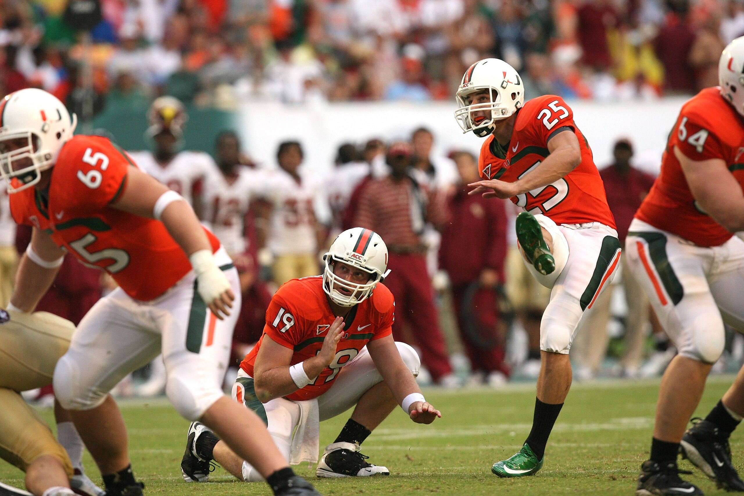 MIAMI - OCTOBER 04:  Place kicker Matt Bosher #25 of the Miami Hurricanes follows his field goal attmept out from under the hold of Matt Perrelli #19 while taking on the Florida State Seminoles at Dolphin Stadium on October 4, 2008 in Miami, Florida. Flor