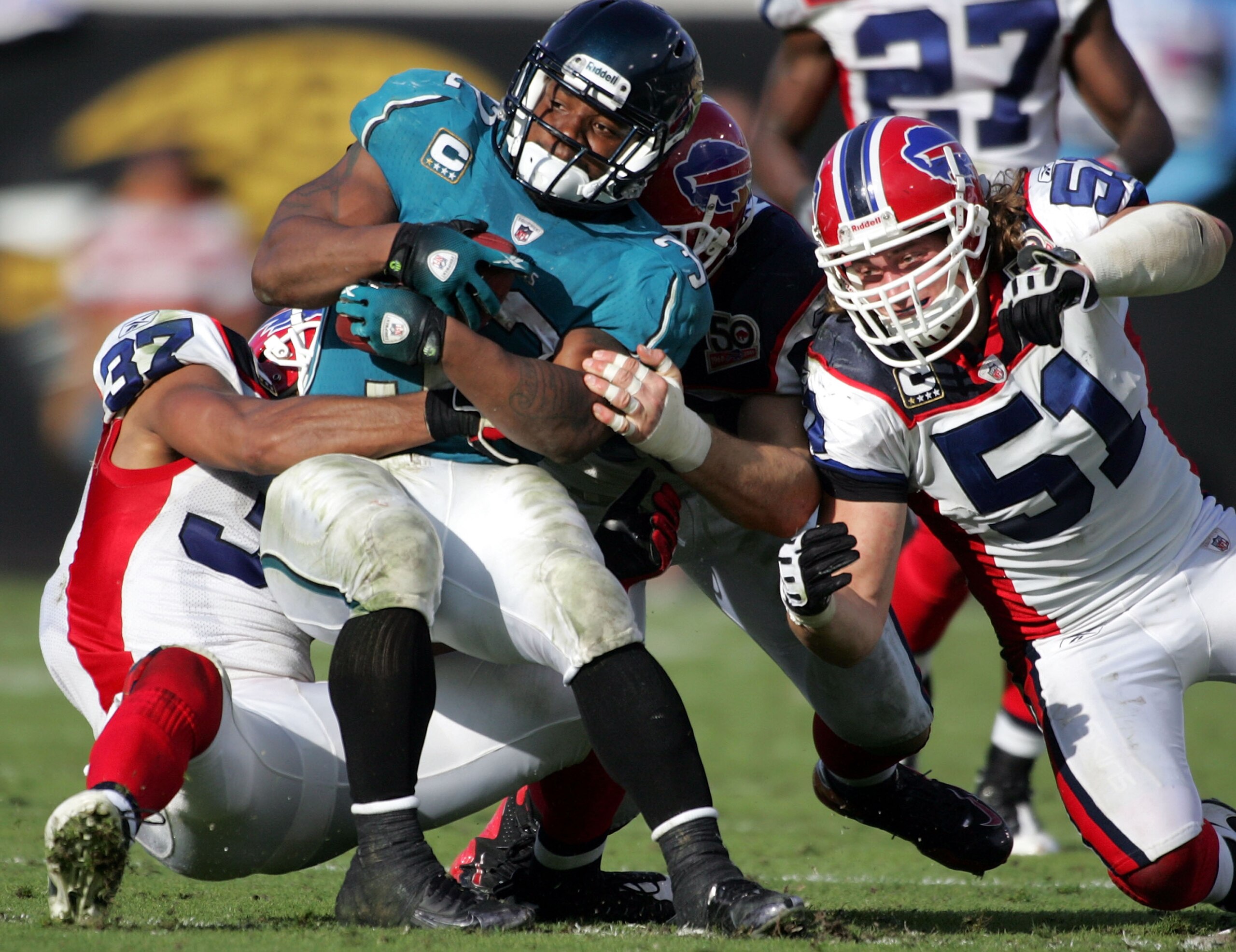 JACKSONVILLE, FL - NOVEMBER 22:  Running back  Maurice Jones Drew #32 of the Jacksonville Jaguars  is brought down by defenders of the Buffalo Bills at Jacksonville Municipal Stadium on November 22, 2009 in Jacksonville, Florida. Jacksonville defeated Buf