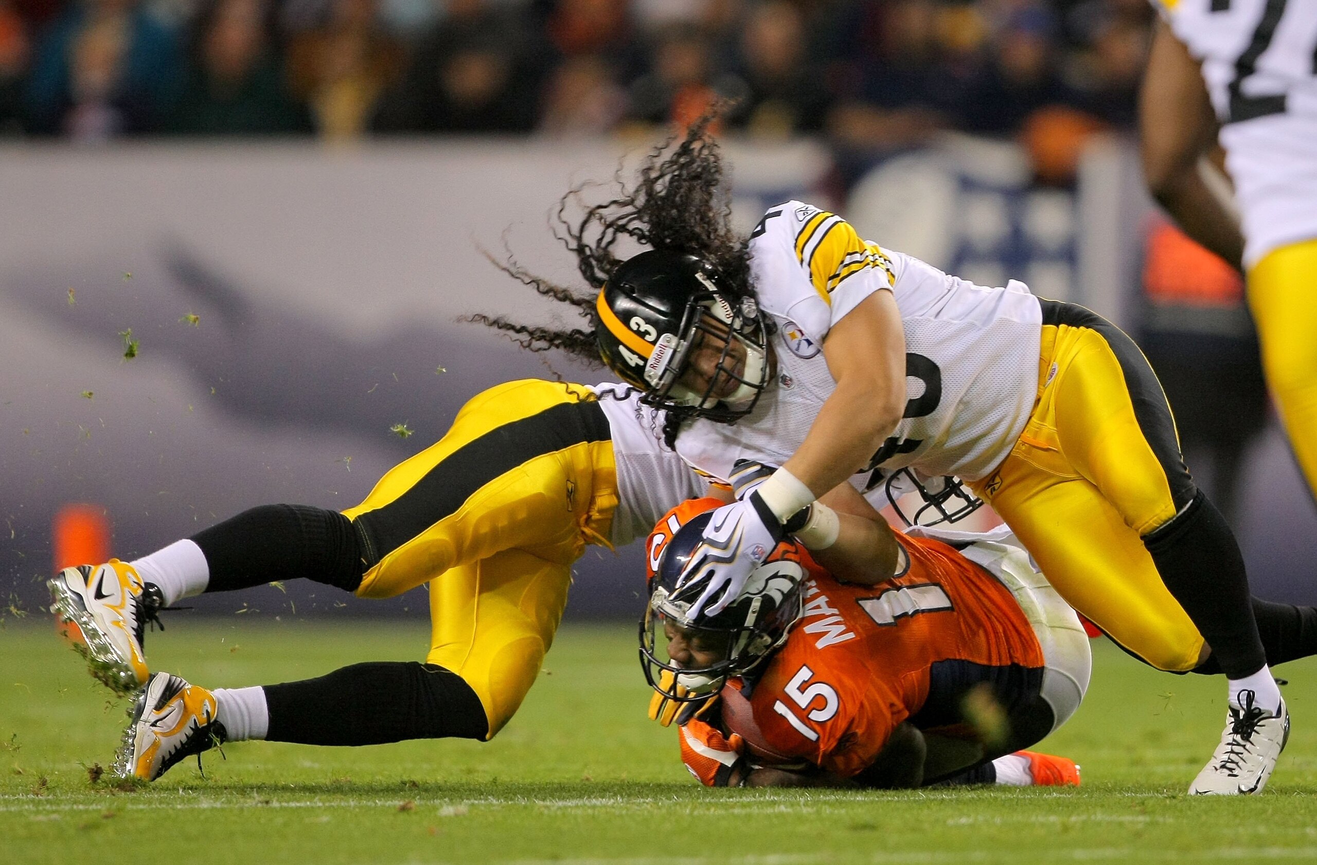 DENVER - NOVEMBER 09:  Brandon Marshall #15 of the Denver Broncos makes a reception and it stopped by Troy Polamalu #43 of the Pittsburgh Steelers on during NFL action at Invesco Field at Mile High on November 9, 2009 in Denver, Colorado. The Steelers def
