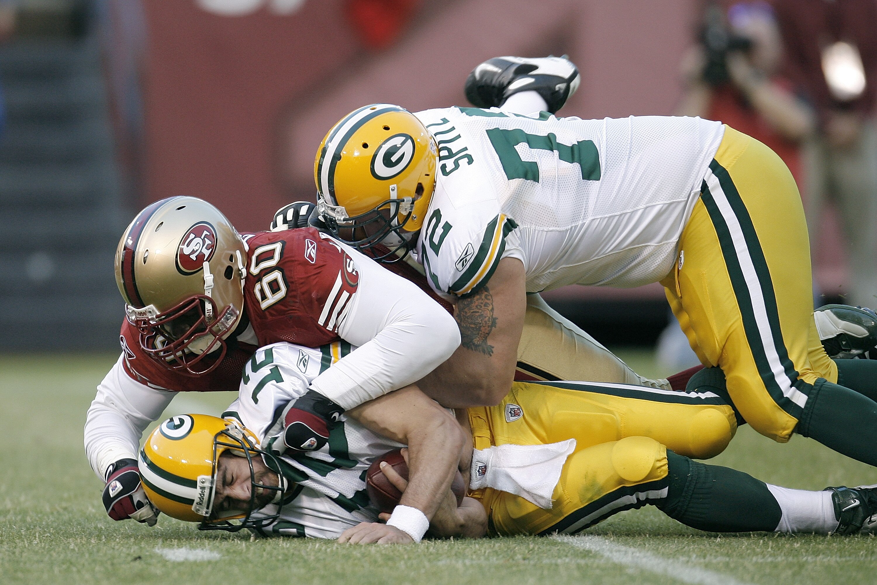 SAN FRANCISC0 - AUGUST 16:  Quarterback Aaron Rodgers #12 of the Green Bay Packers is sacked by defensive lineman Walter Curry #60 of the San Francisco 49ers during a preseason game at Candlestick Park on August 16, 2008 in San Francisco, California.  (Ph