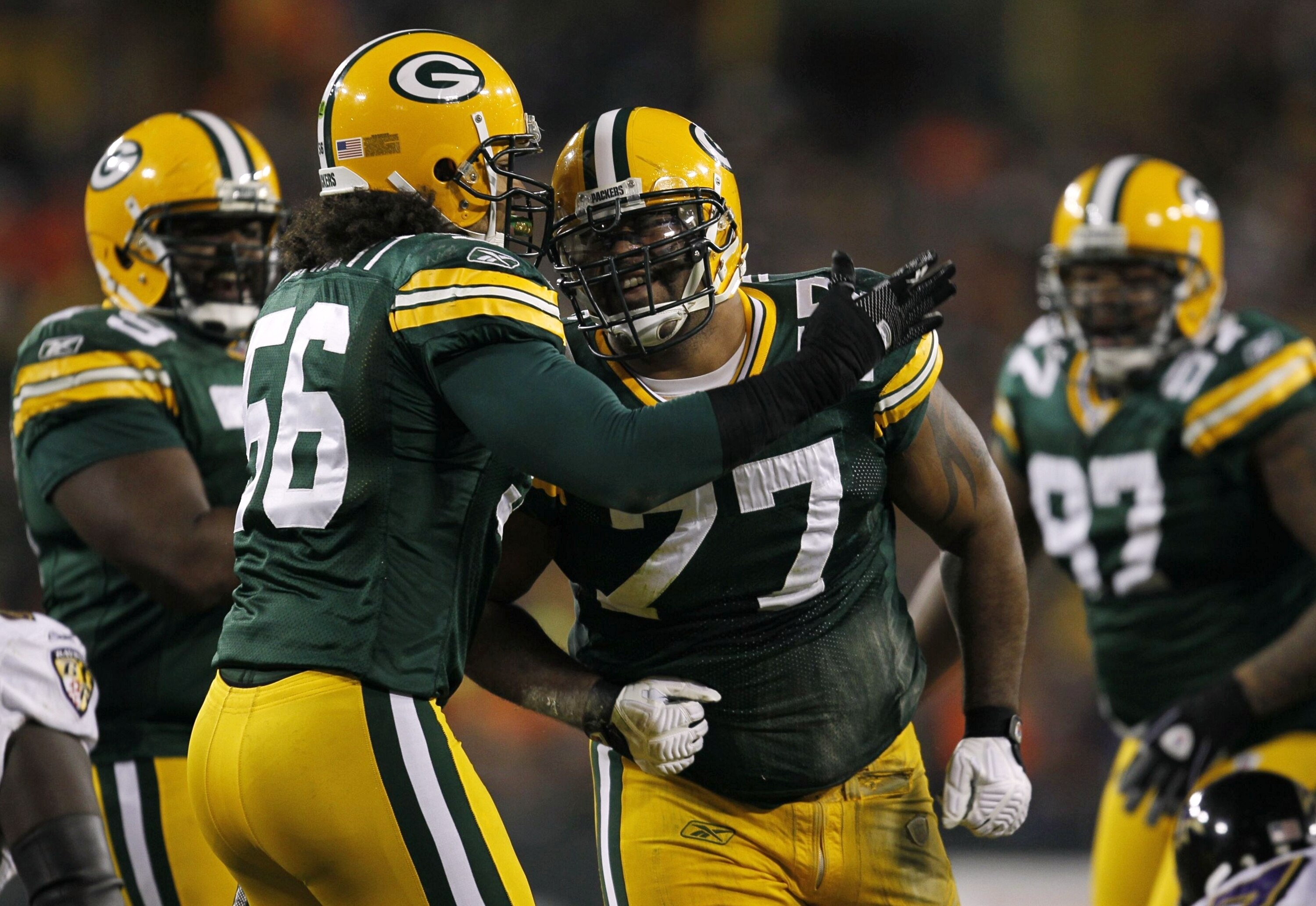 GREEN BAY, WI - DECEMBER 7:  Cullen Jenkins #77 and Nick Barnett #56 of the Green Bay Packers celebrate a defensive play in the first half against the Baltimore Ravens at Lambeau Field on December 7, 2009 in Green Bay, Wisconsin.  (Photo by Jonathan Danie