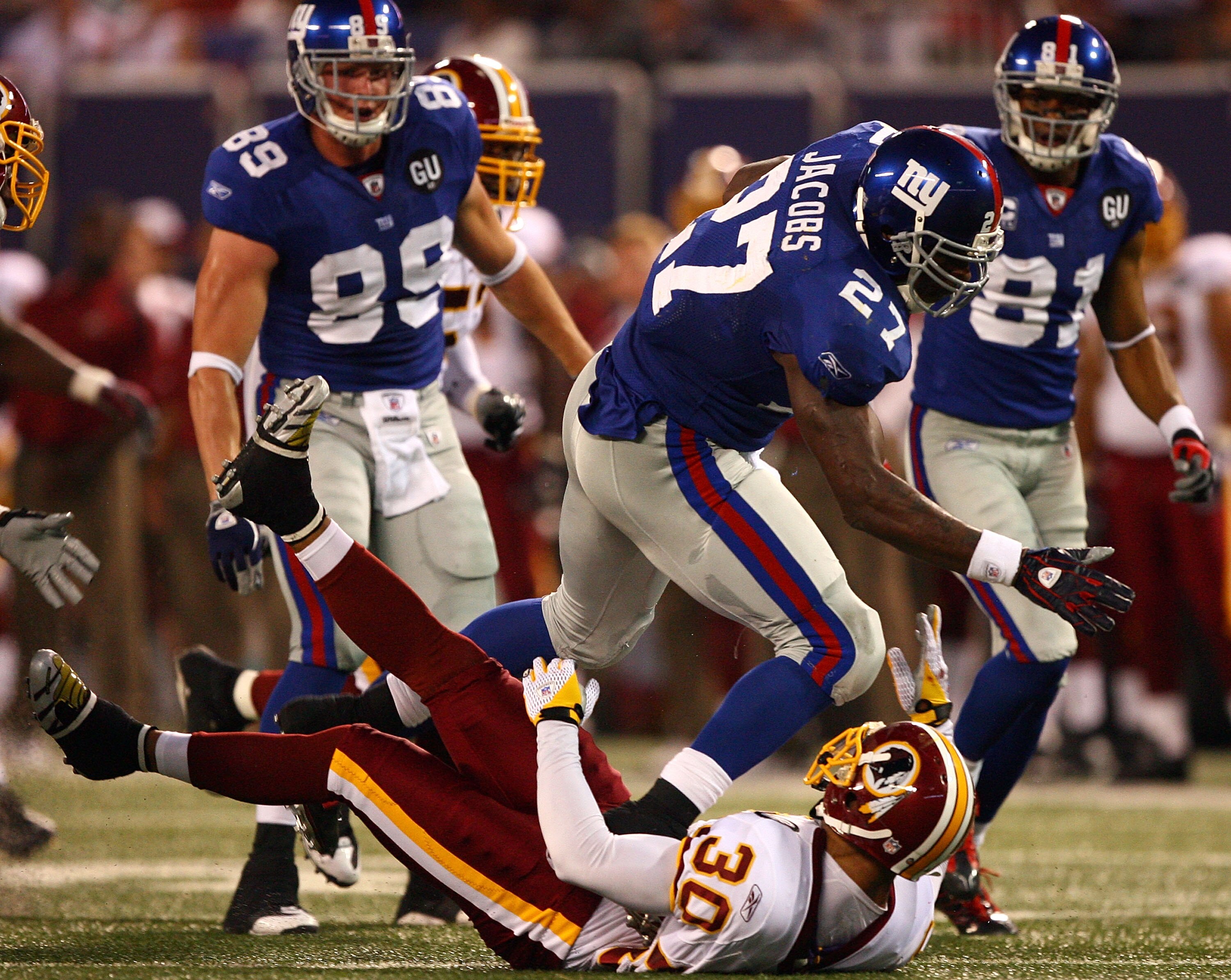 EAST RUTHERFORD, NJ - SEPTEMBER 04:  Brandon Jacobs #27 of the New York Giants runs through the tackle of LaRon Landry #30 of the Washington Redskins at Giants Stadium on September 4, 2008 in East Rutherford, New Jersey  (Photo by Al Bello/Getty Images)