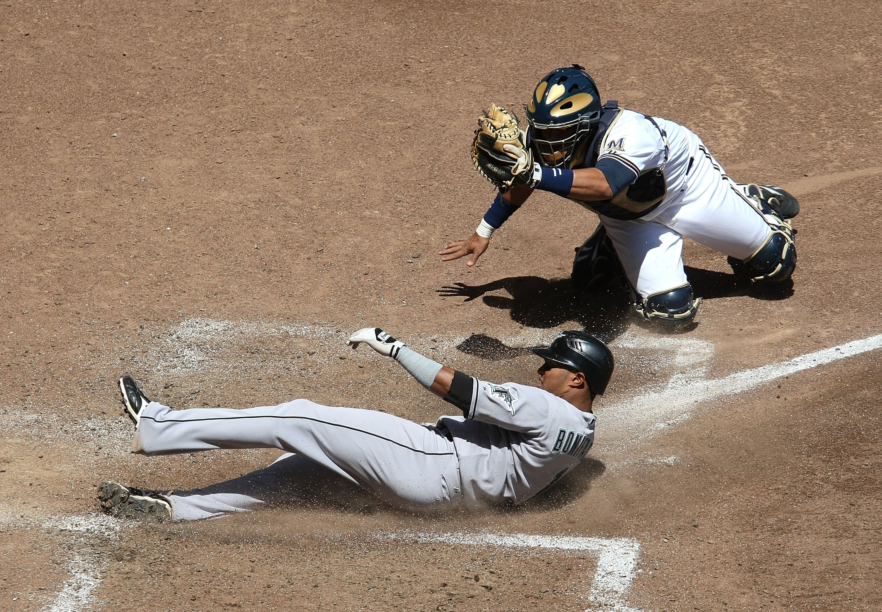 MILWAUKEE - MAY 14: Mike Rivera #11 of the Milwaukee Brewers shows the ball to the umpire after tagging out Emilio Bonifacio #1 of the Florida Marlins in the 5th inning on May 14, 2009 at Miller Park in Milwaukee, Wisconsin. The Brewers defeated the Marli